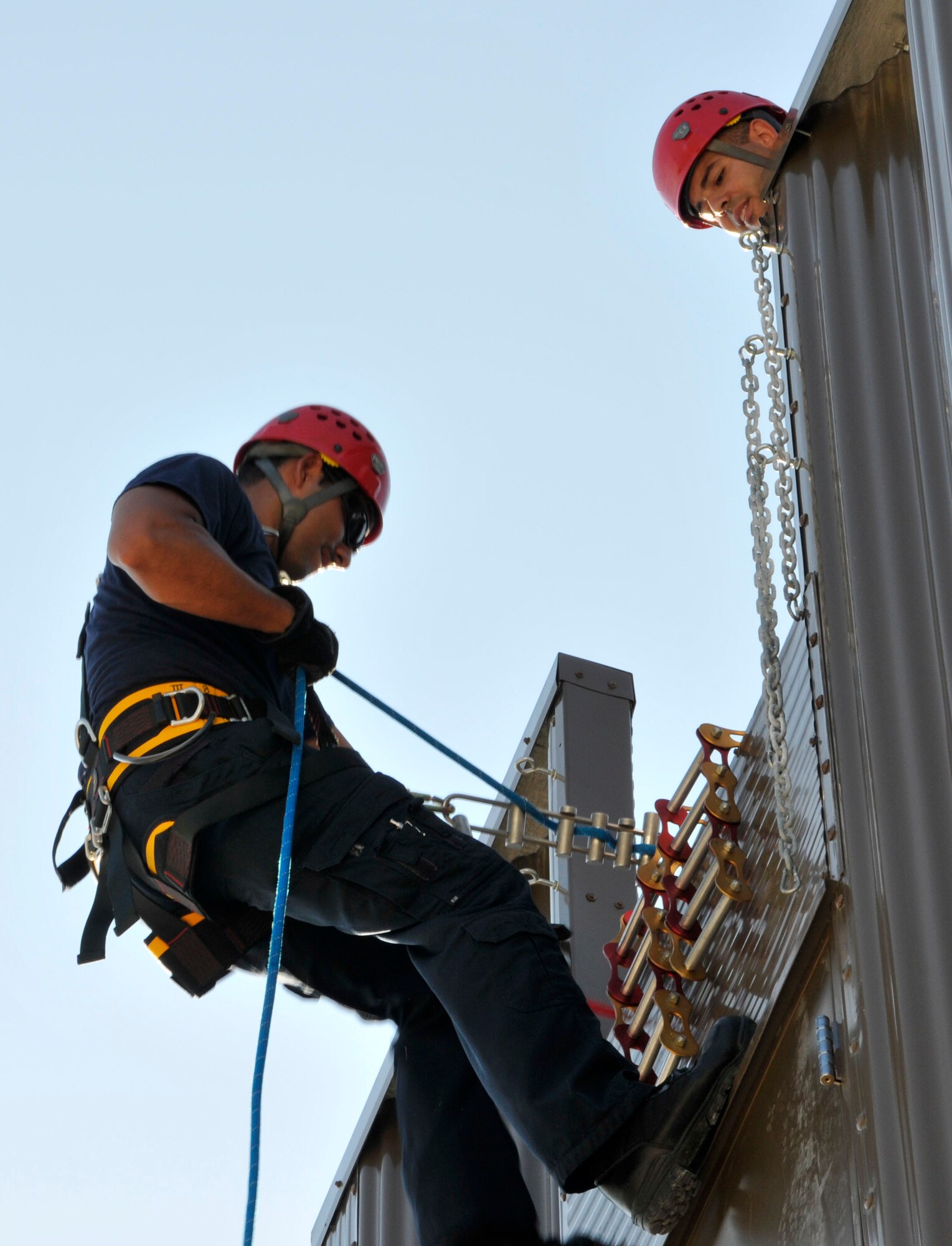 Mr. Fred Amaya, 482nd Fire Department, rappels from the top of their new Class A burn facility as Mr. Alain Diaz, 482nd Fire Department, spots him at Homestead Air Reserve Base, May 30. The burn facility is used for live fire, search and rescue, technical rescue training, as well as several other functions. (U.S. Air Force photo/Ross Tweten)
