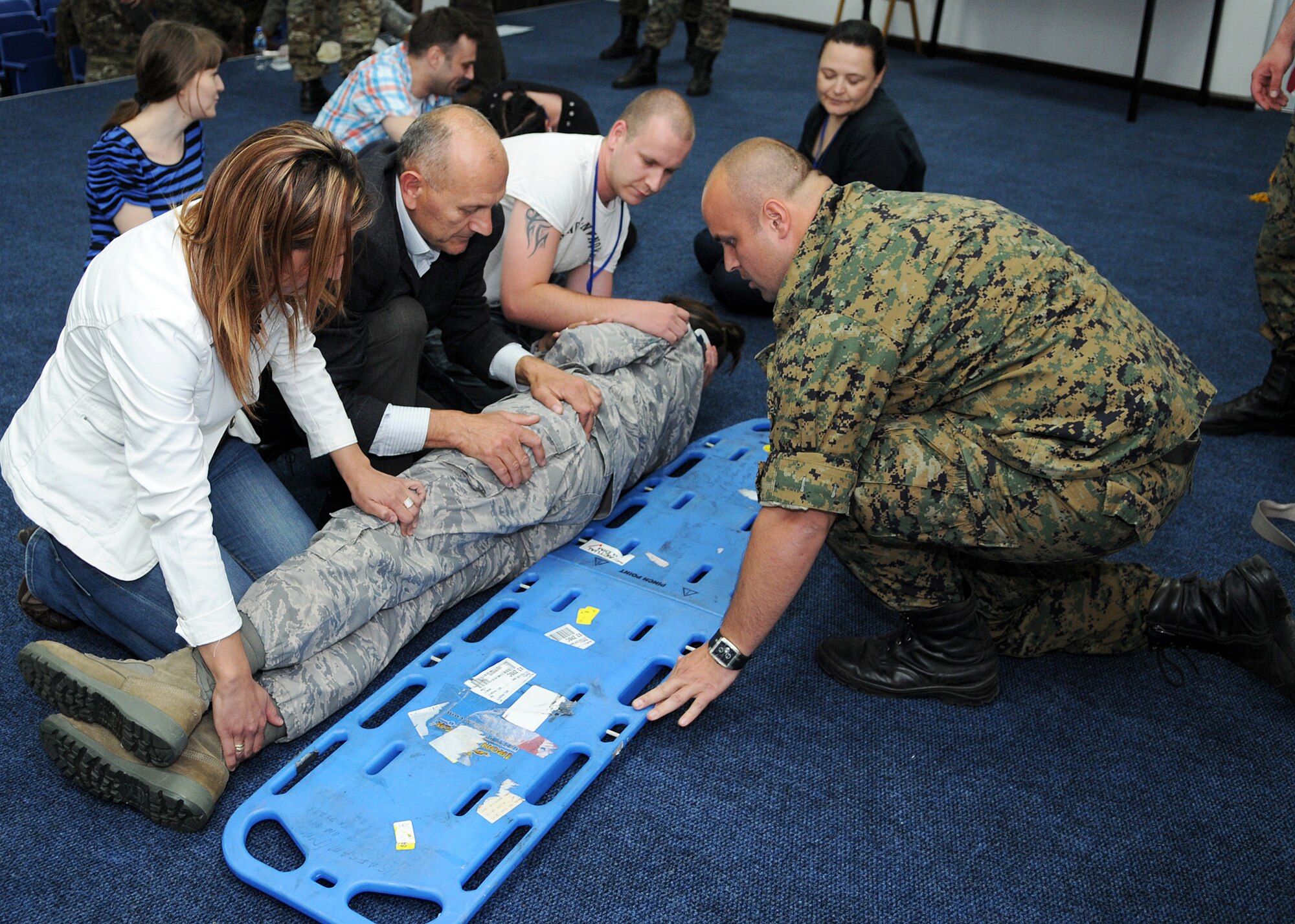 Participants of Shared Resilience 2012 practice a log roll during the Critical Lifesaving Skills for First Responders course here May 29, 2012. During the course, instructors from the Defense Institute for Medical Operations worked with other countries' medical practitioners attending Shared Resilience 2012 to exchange medical ideas and techniques. More than 500 military members from nine nations are participating in the annual U.S. Joint Chiefs of Staff-sponsored exercise May 28 - June 8. The goals of the exercise are to strengthen interoperability, facilitate training in crisis response and disaster management, and validate the readiness of deployable military medical and humanitarian assistance teams. The exercise, in the spirit of partnership for peace, directly supports U.S. European Command's theater cooperation efforts and strategy for active security with European countries.