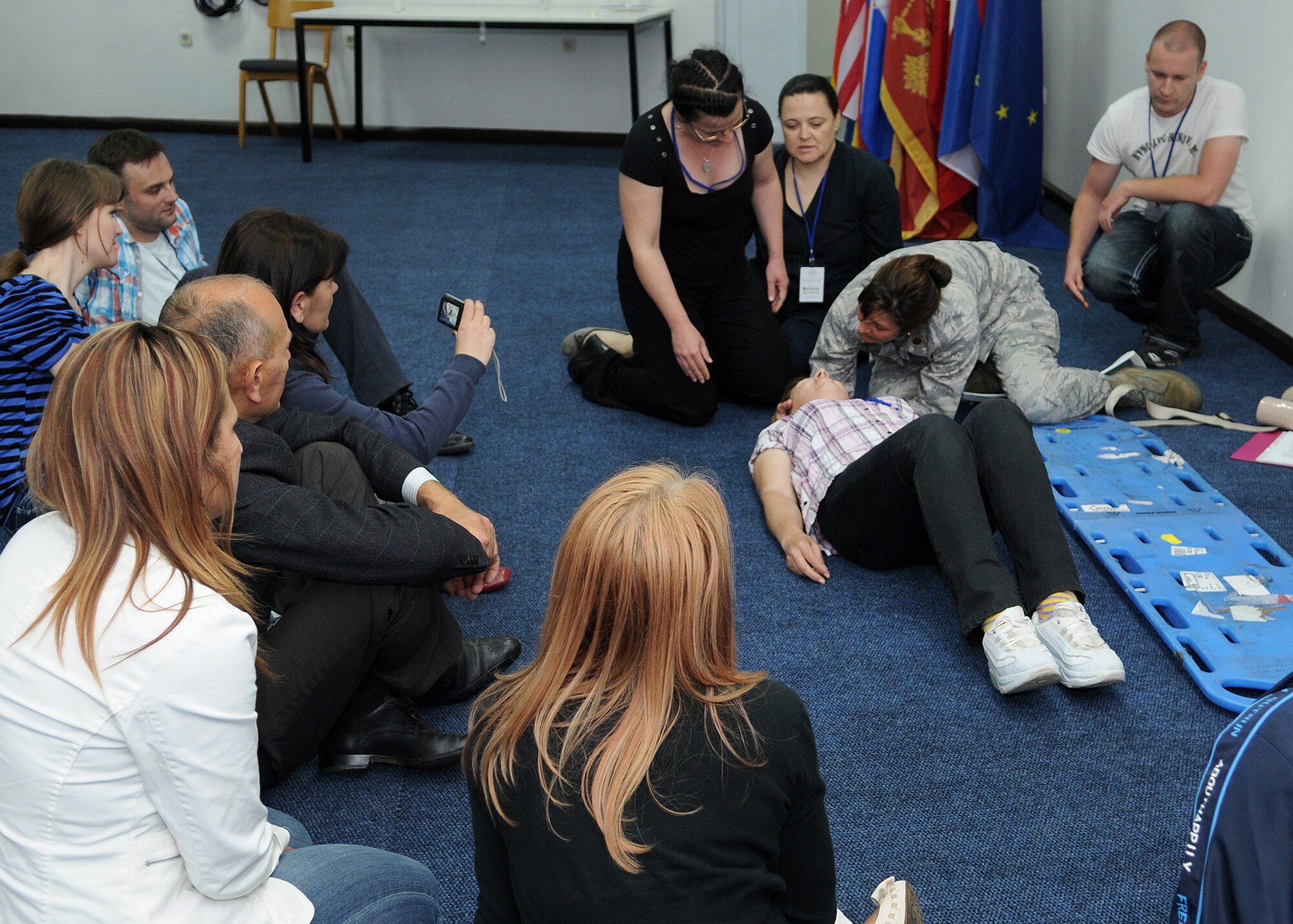 Maj. Courtney Finkbeiner, a Greenwood, Ark., native from the U.S. Air Force School of Aerospace Medicine, Wright-Patterson Air Force Base, Ohio, demonstrates c-spine immobilization during the Critical Lifesaving Skills for First Responders course here May 29, 2012. During the course, instructors from the Defense Institute for Medical Operations worked with other countries' medical practitioners attending Shared Resilience 2012 to exchange medical ideas and techniques. More than 500 military members from nine nations are participating in the annual U.S. Joint Chiefs of Staff-sponsored exercise May 28 - June 8. The goals of the exercise are to strengthen interoperability, facilitate training in crisis response and disaster management, and validate the readiness of deployable military medical and humanitarian assistance teams. The exercise, in the spirit of partnership for peace, directly supports U.S. European Command's theater cooperation efforts and strategy for active security with European countries.