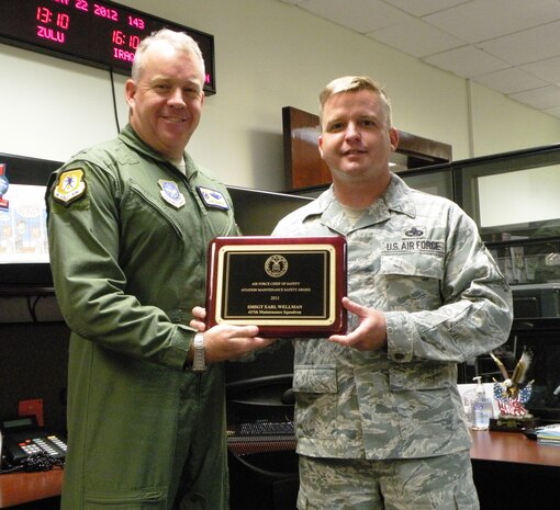 Senior Master Sgt. Earl Wellman, a Quality Assurance chief inspector and Lead Production superintendent from the 437th Maintenance Group, Joint Base Charleston, S.C., is presented with an Air Force Safety Award by Col. Erik Hansen, 437th Airlift Wing commander, May 22, 2012. Wellman mentored 20 inspectors through 5,000 inspections while executing the Maintenance Standardization and Evaluating Program. (Courtesy photo)