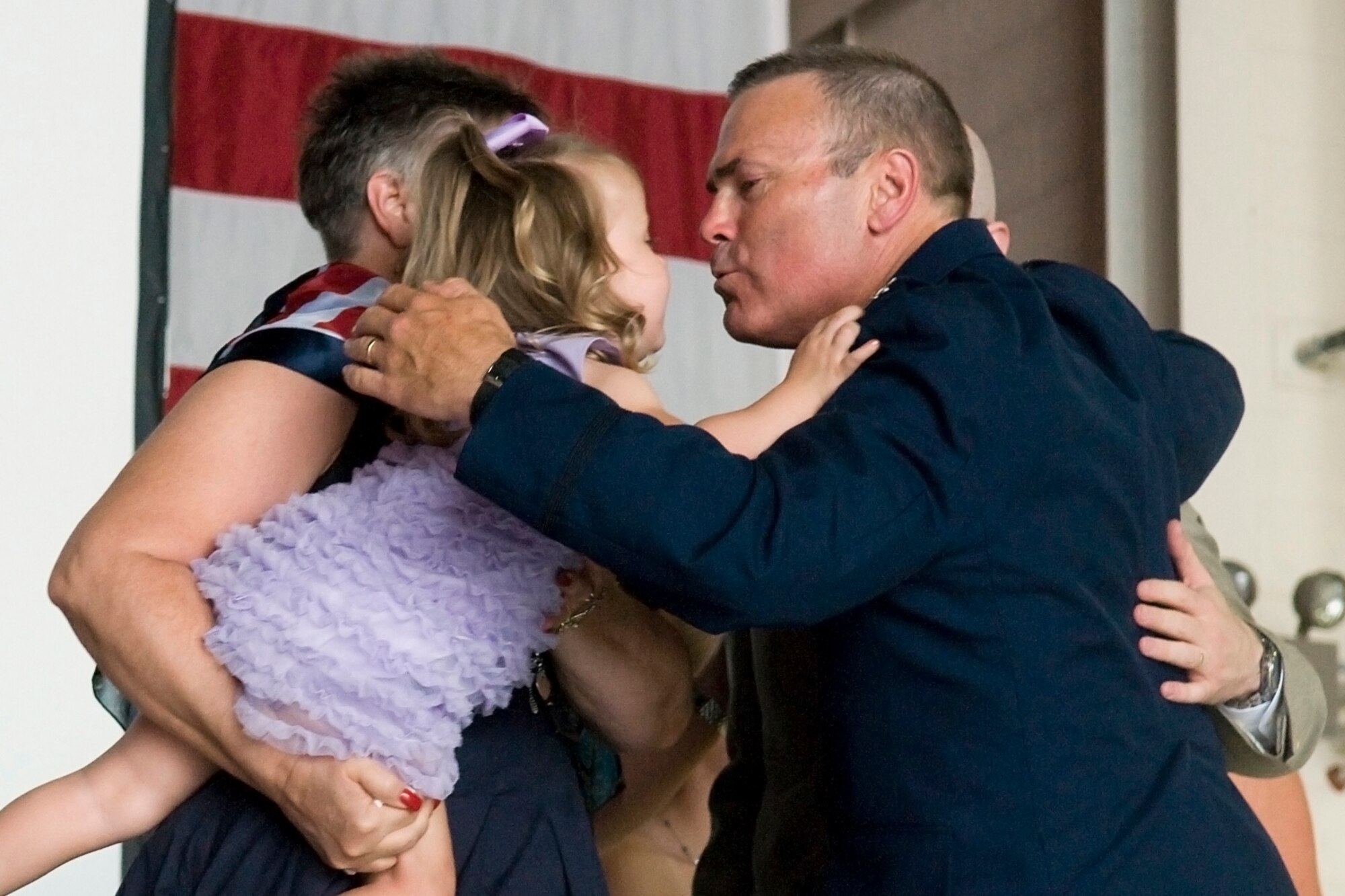GRISSOM AIR RESERVE BASE, Ind. -- Col. William T. "Tim" Cahoon gives his granddaughter a kiss on stage as his family embraces him shortly after his retirement ceremony here May 20. Cahoon retired after 35 years in the Air Force. (U.S. Air Force photo/Senior Airman Jami K. Lancette)
