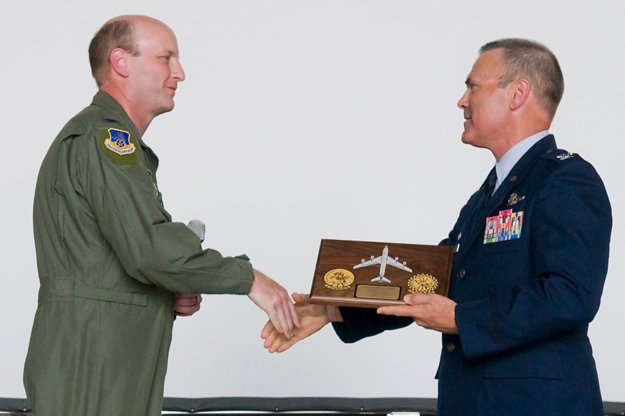 GRISSOM AIR RESERVE BASE, Ind. -- Col. Christopher Amend, left, shakes the hand of Col. William T. "Tim" Cahoon after giving him the "highly coveted" 434th Operations Group plaque during Cahoon's retirement ceremony here May 20. Amend is the 434th OG commander.  (U.S. Air Force photo/Senior Airman Jami K. Lancette)
