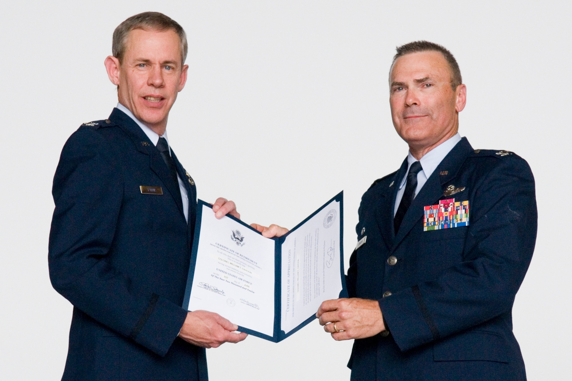 GRISSOM AIR RESERVE BASE, Ind. -- Col. William T. "Tim" Cahoon, 434th Air Refueling Wing commander, receives his certificate of retirement from retired Col. Ronald Farris during his retirement ceremony May 20 at Grissom. Cahoon retired after nearly 35 years of service in the Air Force. (U.S. Air Force photo/Senior Airman Jami K. Lancette)