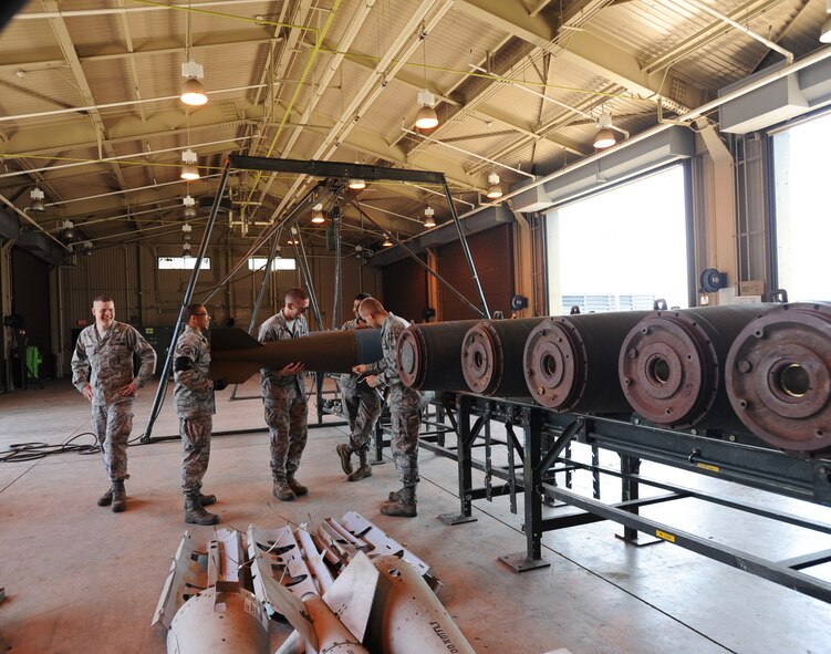 U.S. Air Force munitions crew members work to remove the fin assembly of a BDU-50 training munition at Misawa Air Base, Japan, May 31, 2012. There are multiple different fin assemblies that can be attached to munitions; each has its own purpose. (U.S. Air Force photo by Airman Kenna Jackson/Released)