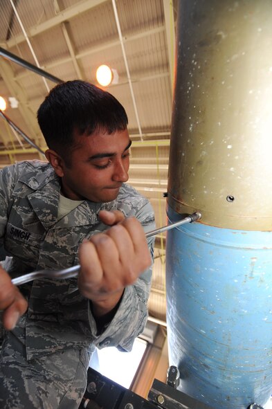 U.S. Air Force Airman 1st Class Rattan Singh, 35th Maintenance Squadron conventional maintenance crew member, loosens a screw from a fin assembly on to a BDU-50 training device at Misawa Air Base, Japan, May 31, 2012. There are multiple screws that connect the fin assembly to the bomb. (U.S. Air Force photo by Airman Kenna Jackson/Released)