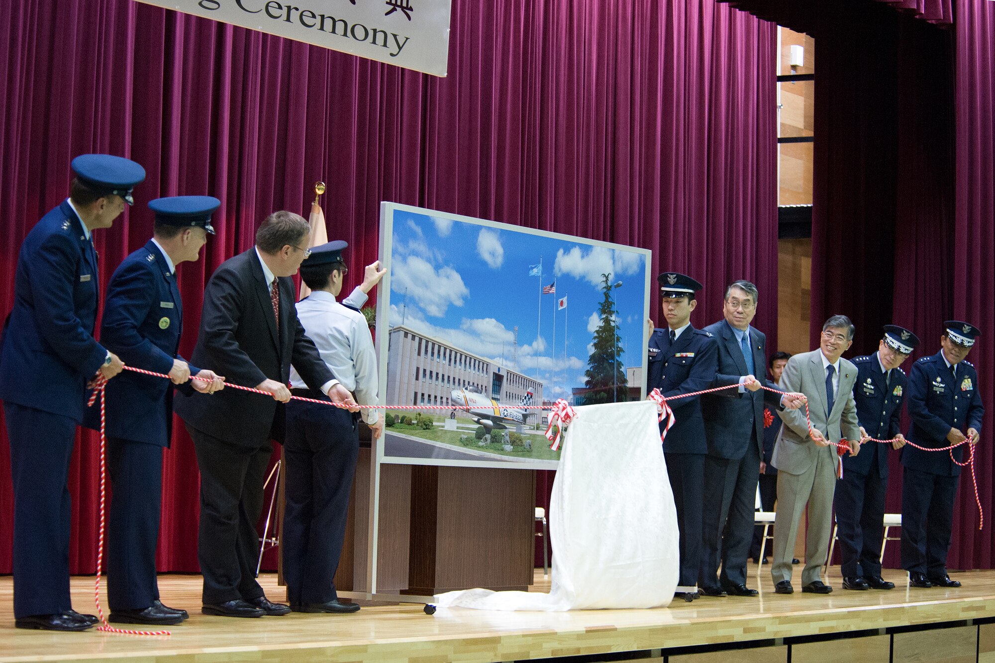 YOKOTA AIR BASE, Japan -- Senior Japanese and U.S. guests unveil a picture honoring the Japan-U.S. Alliance during the Japan Air Self-Defense Force Air Defense Command Headquarters grand opening ceremony at Yokota Air Base, Japan, May 30, 2012. The ADC headquarters was relocated from Fuchu Air Base as part of the 2006 Realignment Roadmap, a bilateral initiative to enhance the U.S.-Japan Security Alliance and address force realignments in the Pacific. (U.S. Air Force photo by Airman 1st Class John D. Partlow) 