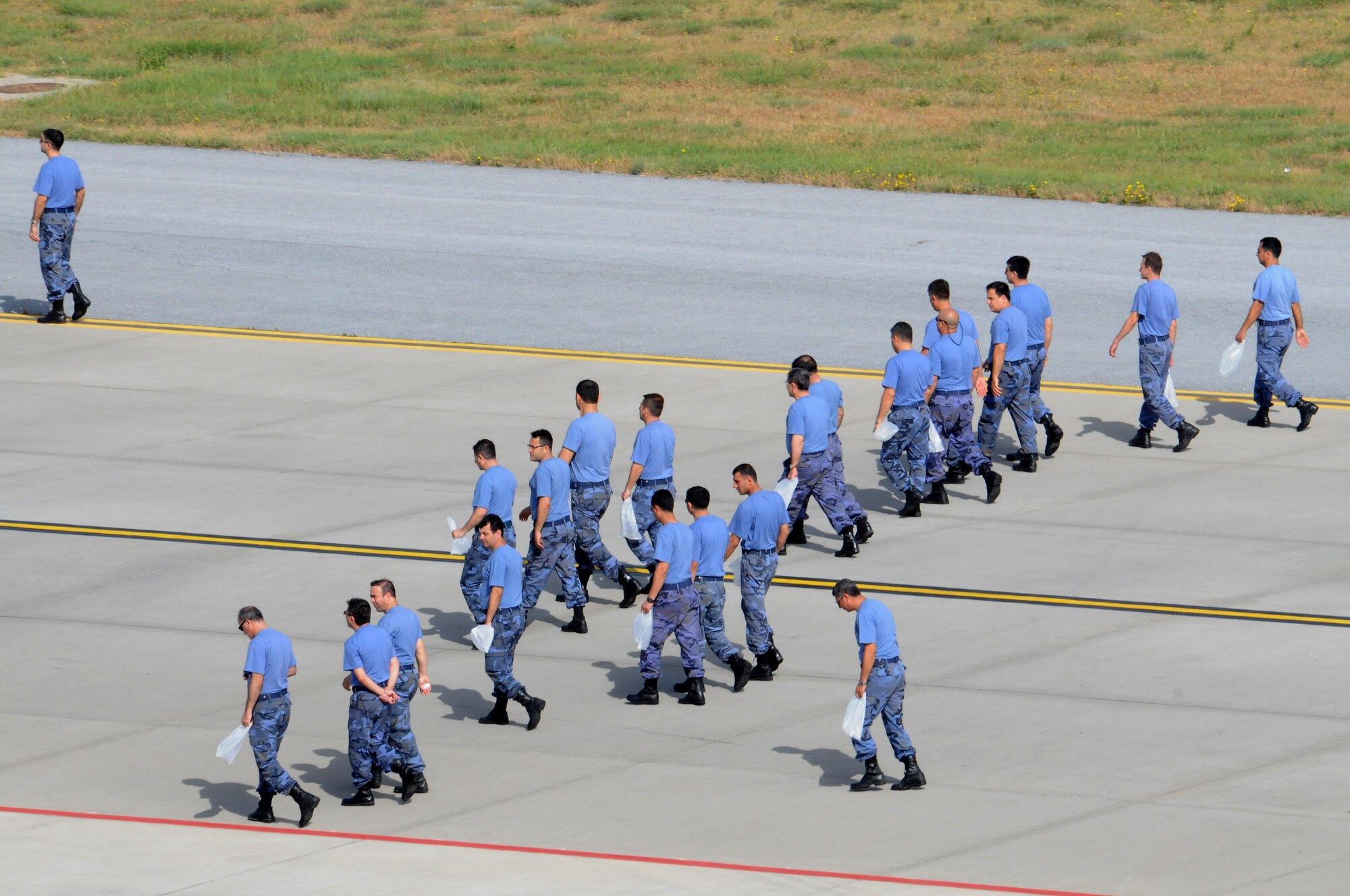 Turkish air force airmen from the 10th Tanker Base Command walk across the flightline during a foreign-object-debris walk May 29, 2012, at Incirlik Air Base, Turkey. The FOD walk was a combined effort between the 39th Air Base Wing and the Turkish air force 10th Tanker Base Command to clear the area of  debris that could potentially damage aircraft engines. (U.S. Air Force photo by Senior Airman Marissa Tucker/Released)