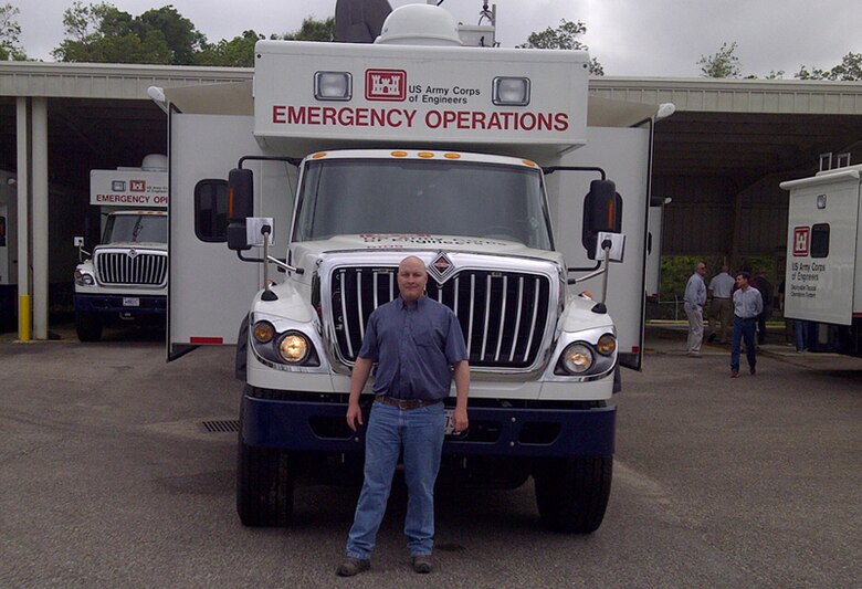 Trent Simpler stands in front of one of the Corps’ emergency operations response vehicles kept ready for deployment. 