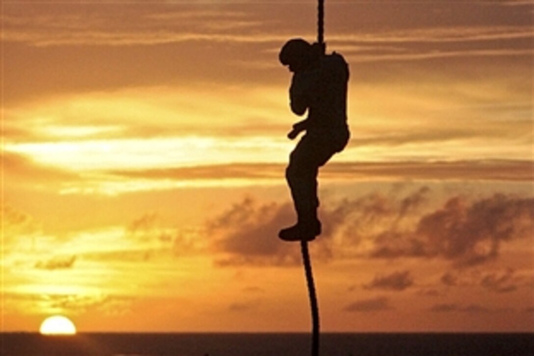 A Marine fast ropes from a UH-1Y Huey onto USS Makin Island in the U.S. Navy's 5th Fleet area of responsibility, May 31, 2012. The Marine is assigned to the 3rd Battallion, 1st Marine Regiment, 11th Marine Expeditionary Unit, which is deployed as part of the Makin Island Ready Group, a U.S. Central Command theater reserve force.