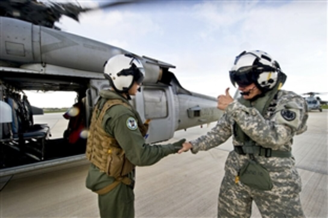 Army Gen. Martin E. Dempsey, chairman of the Joint Chiefs of Staff, gives a thumbs up as he talks with a Navy SH-60 Seahawk helicopter crew chief on Andersen Air Force Base, Guam, May 30, 2012.