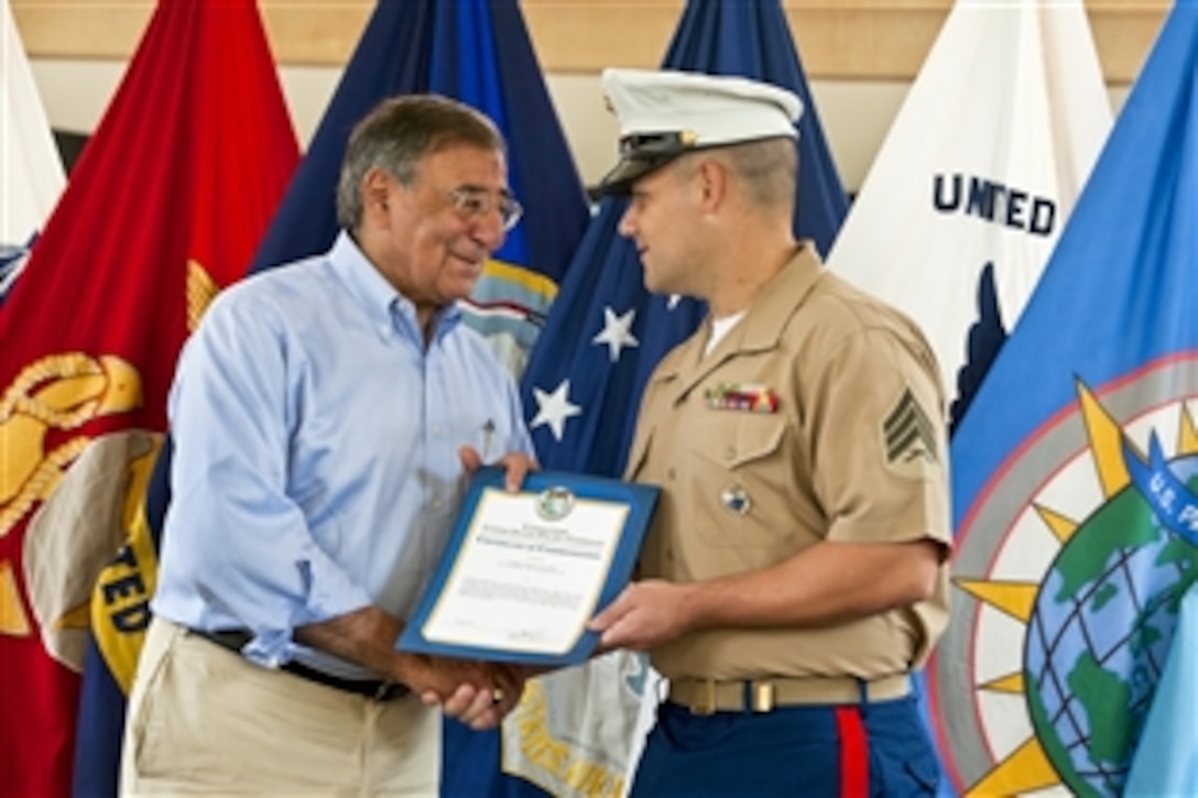 Defense Secretary Leon E. Panetta presents Sgt. David Long a certificate of commendation on a visit to U.S. Pacific Command headquarters on Camp H.M. Smith, Hawaii, May 31, 2012. Panetta is on a 10-day trip to the Asia-Pacific region to meet with defense counterparts.
