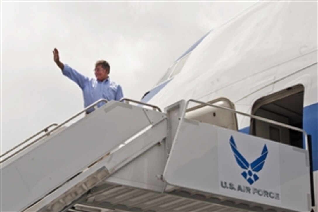 Defense Secretary  Leon E. Panetta waves as he departs from Hickam Air Force Base, Hawaii, May 31, 2012. Panetta is on a 10-day trip to the Asia-Pacific region to meet with defense counterparts.