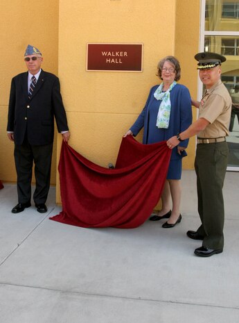 Kenneth and Nancy Walker unveil the Walker Hall plaque with the help of Brig. Gen. Daniel D. Yoo, commanding general, Marine Corps Recruit Depot San Diego and Western Recruiting Region at the Walker Hall Dedication Ceremony May 10 aboard MCRD San Diego. Walker Hall is a sports-medicine complex named after the fallen Marine, Staff Sgt. Allan K. Walker, who served as a drill instructor aboard the depot. Walker was killed in action April 6, 2004 in support of Operation Iraqi Freedom.
