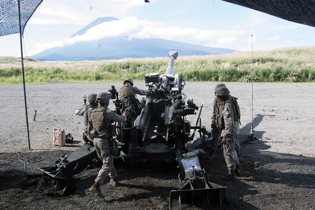 Marines from Battery O, 5th Battalion, 14th Marine Regiment, 4th Marine Division prepare to fire artillery rounds from an M777A2 155 mm howitzer at East Fuji Maneuver Area, Japan Sept. 11. Battery O is in Japan as a part of the Unit Deployment Program, a program designed to increase the training level and unit continuity of Marine Corps units stationed in the continental United States. Realistic scenarios and combined exercises are a highlight of the UDP, bringing Marines of many different units together, sometimes with foreign forces.