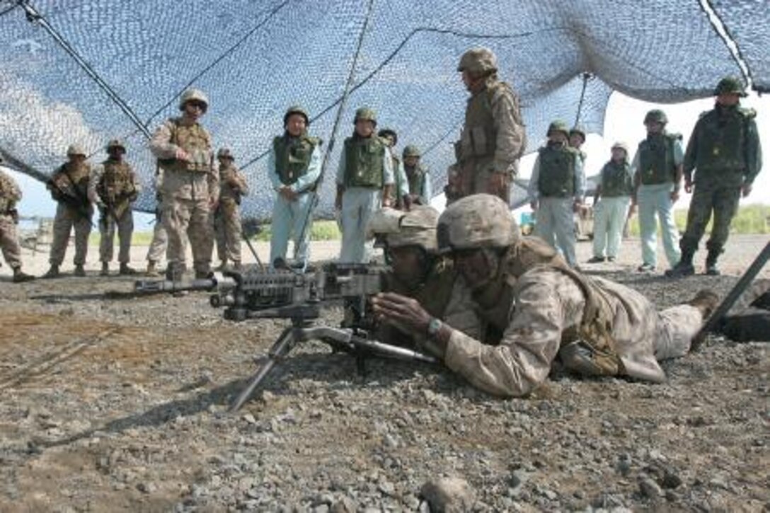 Marines with Battery O, 5th Battalion, 14th Marine Regiment, simulate firing an M240G medium machine gun during a demonstration for local government officials at East Fuji Maneuver Area on mainland Japan Sept. 14. Battery O is currently deployed to Okinawa, Japan as a part of the Unit Deployment Program, a program designed to increase the training level and unit continuity of Marine Corps units stationed in the continental United States. Units with Marine Forces Reserve have honed their skills in the UDP since 2003, and continue to do so, as two squadrons from the 4th Marine Aircraft Wing are set to mobilize for their UDP deployment in 2013.