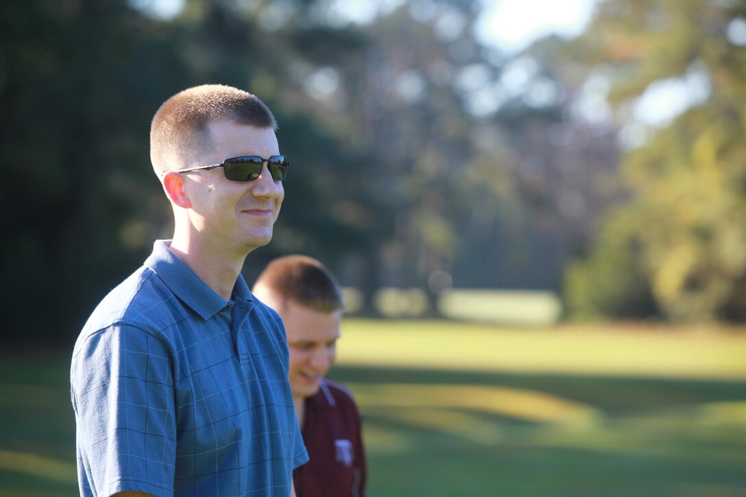 1st Lt. Timothy A. Burnam (foreground) and Capt. John E. Conrad Jr., communications officers with Combat Logistics Regiment 27, 2nd Marine Logistics Group, share a laugh after a teammate misses the hole during a golf-tournament fundraiser at the Paradise Point golf course aboard Camp Lejeune, N.C., Oct. 24, 2012. CLR-27 organized the event to support its Marine Corps Birthday Ball.