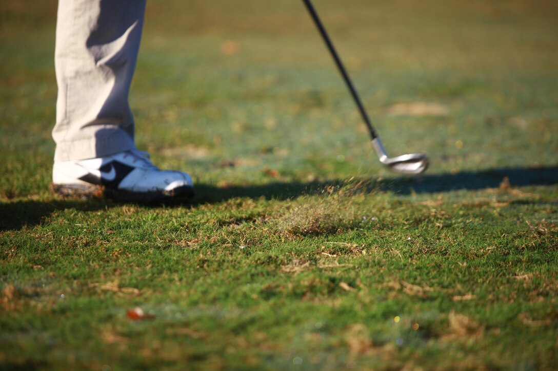 A Marine with Combat Logistics Regiment 27, 2nd Marine Logistics Group makes grass fly as he drives a ball toward the 17th hole of the Scarlet golf course aboard Camp Lejeune, N.C., Oct. 24, 2012. The regiment held the golf tournament to raise money for its annual Marine Corps Birthday Ball and to build camaraderie within the unit.