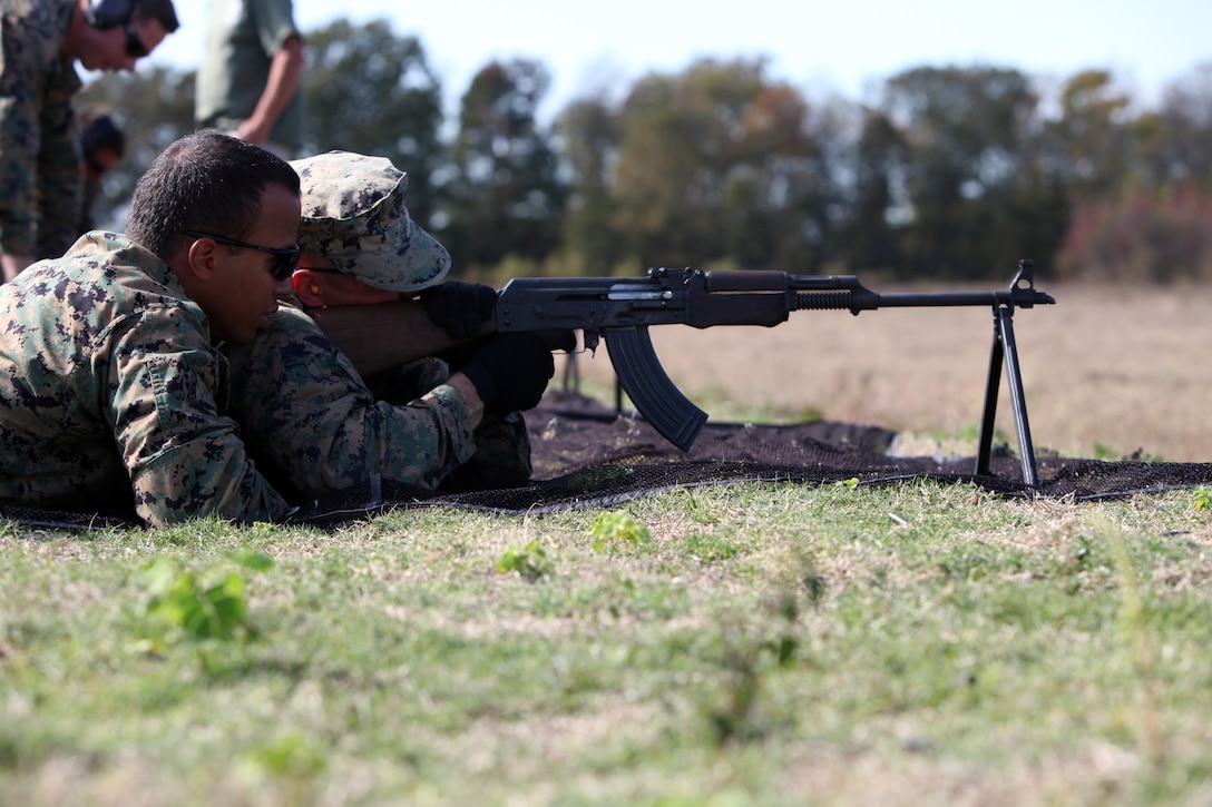 Sgt. Geoffrey Andrade and Sgt. Brian Oldaker, with Special-Purpose Marine Air-Ground Task Force Africa, use the buddy system to fire a foreign machine gun during a training session at the Tier 1 Group Training Facility in Crawfordsville, Ark., Oct. 23, 2012. The Marines and Sailors of Special-Purpose MAGTF Africa learned ho to operate and maintain various foreign weapons in preparation for their upcoming deployment.