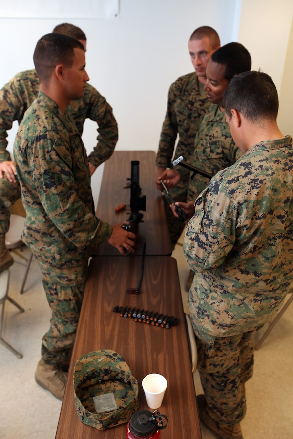 arines with Special-Purpose Marine Air-Ground Task Force Africa discuss how to assemble and disassemble a foreign machine gun at the Tier 1 Group Training Facility in, Crawfordsville, Ark., Oct. 23, 2012. The Marines and Sailors of Special-Purpose MAGTF Africa learned ho to operate and maintain various foreign weapons in preparation for their upcoming deployment.