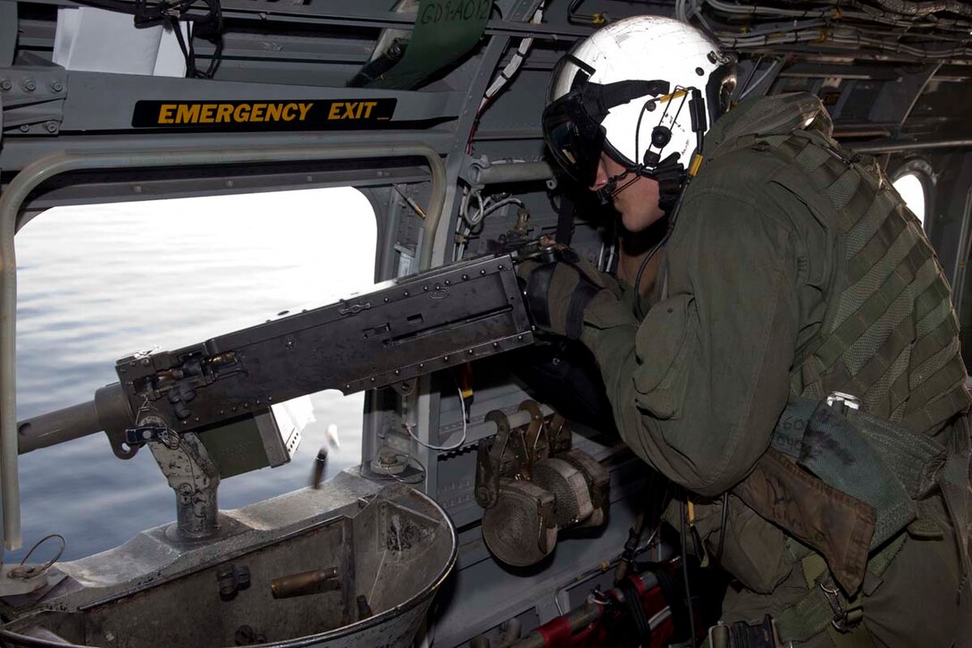 Corporal Heriberto Velazquez II, CH-46E aerial observer and mechanic, Marine Medium Helicopter Squadron 364 (Rein.), 15th Marine Expeditionary Unit, fires a XM-218 machine gun while flying over the Indian Ocean, Oct. 25. Marine Medium Helicopter Squadron 364 (Rein.), 15th Marine Expeditionary Unit conducted aerial gunnery and tail gunnery training to refresh the skills of eight of the unit’s crew chiefs as well as aerial tail gunnery qualifications for two of their aerial observers. The 15th MEU is comprised of approximately 2,400 Marines and sailors and is currently embarked as part of the Peleliu Amphibious Ready Group, while they serve as the nation's rapid-response sea-based Marine Air Ground Task Force for Western Pacific Deployment 12-02. Champ, 26, is from Bedford, Iowa. 