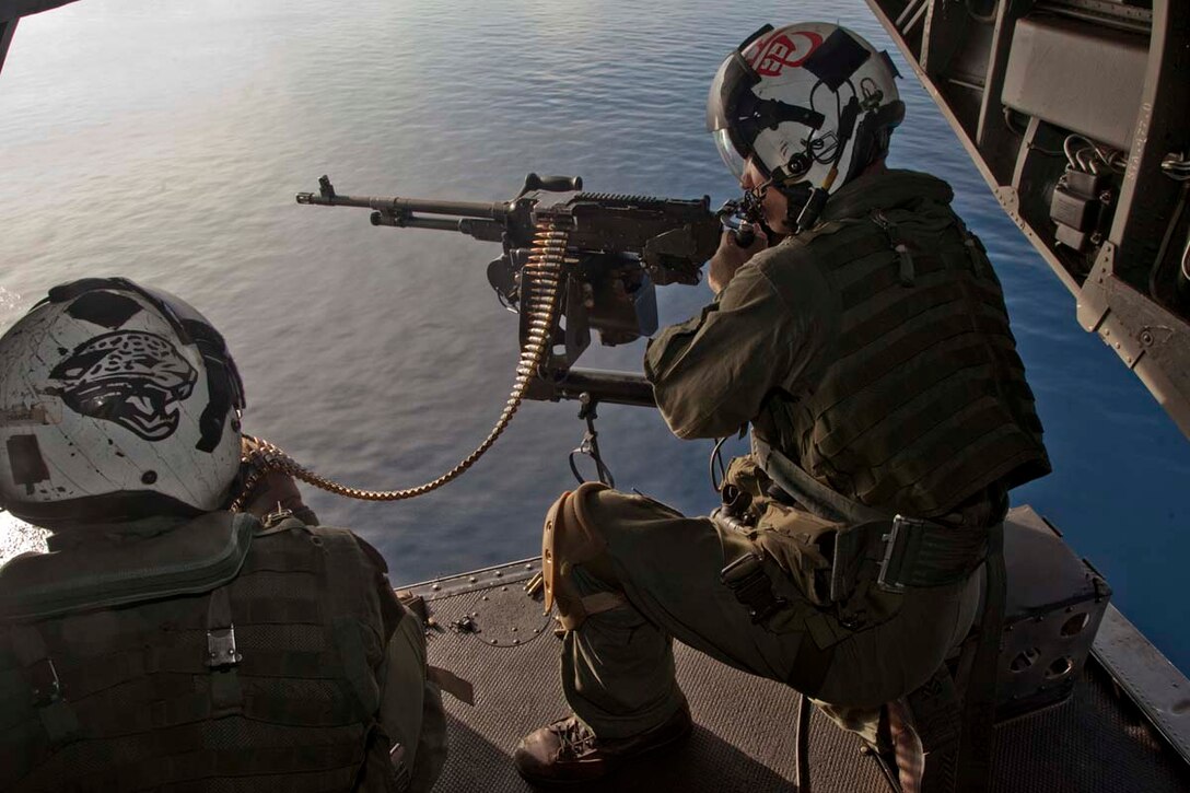 Sergeant Kyle M. Crance, weapons and tactics instructor and CH-46E Sea Knight crew chief, Marine Medium Helicopter Squadron 364 (Rein.), 15th Marine Expeditionary Unit, prepares to fire a M240D machine gun while flying over the Indian Ocean, Oct. 25. Marine Medium Helicopter Squadron 364 (Rein.), 15th Marine Expeditionary Unit conducted aerial gunnery and tail gunnery training to refresh the skills of eight of the unit’s crew chiefs as well as aerial tail gunnery qualifications for two of their aerial observers. The 15th MEU is comprised of approximately 2,400 Marines and sailors and is currently embarked as part of the Peleliu Amphibious Ready Group, while they serve as the nation's rapid-response sea-based Marine Air Ground Task Force for Western Pacific Deployment 12-02. Crance, 24, is from Atlanta Beach, Fla.