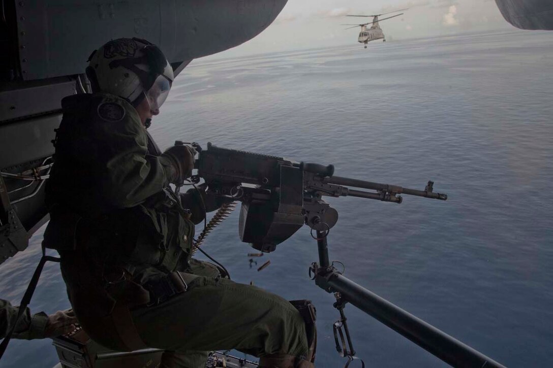 Sergeant Kyle M. Crance, weapons and tactics instructor and CH-46E Sea Knight crew chief, Marine Medium Helicopter Squadron 364 (Rein.), 15th Marine Expeditionary Unit, fires a M240D machine gun while flying over the Indian Ocean, Oct. 25. Marine Medium Helicopter Squadron 364 (Rein.), 15th Marine Expeditionary Unit conducted aerial gunnery and tail gunnery training to refresh the skills of eight of the unit’s crew chiefs as well as aerial tail gunnery qualifications for two of their aerial observers. The 15th MEU is comprised of approximately 2,400 Marines and sailors and is currently embarked as part of the Peleliu Amphibious Ready Group, while they serve as the nation's rapid-response sea-based Marine Air Ground Task Force for Western Pacific Deployment 12-02. Crance, 24, is from Atlanta Beach, Fla. 