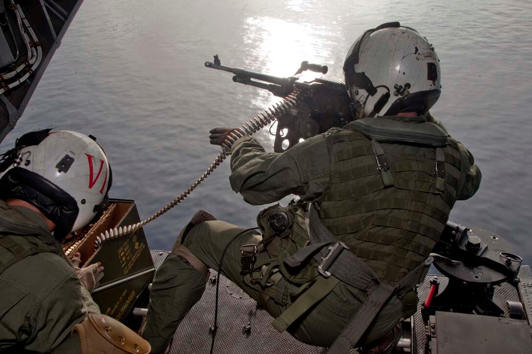 Sergeant Kyle M. Crance, weapons and tactics instructor and CH-46E Sea Knight crew chief, Marine Medium Helicopter Squadron 364 (Rein.), 15th Marine Expeditionary Unit, fires a M240D machine gun while flying over the Indian Ocean, Oct. 25. Marine Medium Helicopter Squadron 364 (Rein.), 15th Marine Expeditionary Unit conducted aerial gunnery and tail gunnery training to refresh the skills of eight of the unit’s crew chiefs as well as aerial tail gunnery qualifications for two of their aerial observers. The 15th MEU is comprised of approximately 2,400 Marines and sailors and is currently embarked as part of the Peleliu Amphibious Ready Group, while they serve as the nation's rapid-response sea-based Marine Air Ground Task Force for Western Pacific Deployment 12-02. Crance, 24, is from Atlanta Beach, Fla.
