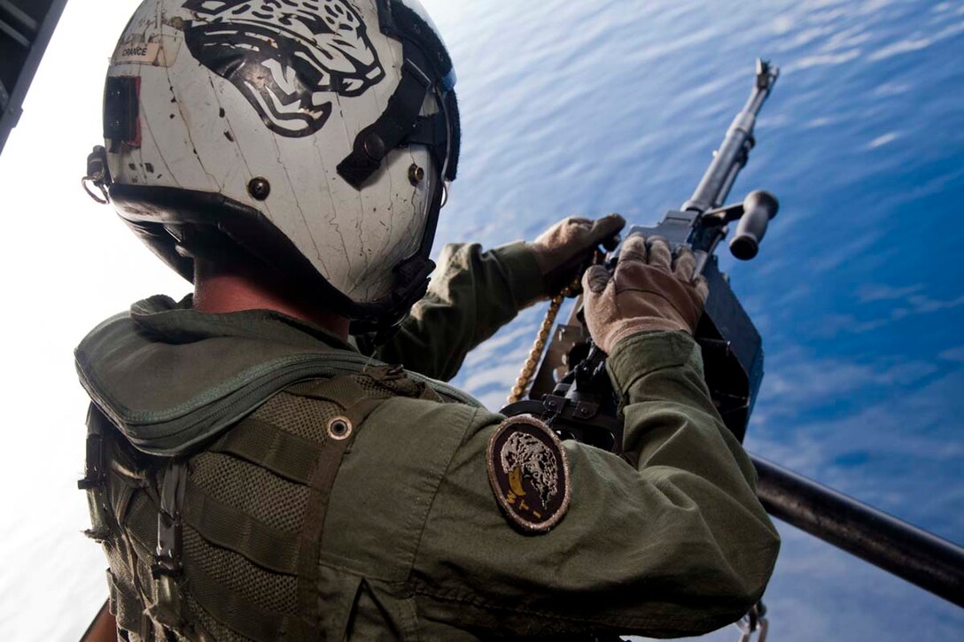 Sergeant Kyle M. Crance, weapons and tactics instructor and CH-46E Sea Knight crew chief, Marine Medium Helicopter Squadron 364 (Rein.), 15th Marine Expeditionary Unit, loads 7.62mm rounds into a M240D machine gun while flying over the Indian Ocean, Oct. 25. Marine Medium Helicopter Squadron 364 (Rein.), 15th Marine Expeditionary Unit conducted aerial gunnery and tail gunnery training to refresh the skills of eight of the unit’s crew chiefs as well as aerial tail gunnery qualifications for two of their aerial observers. The 15th MEU is comprised of approximately 2,400 Marines and sailors and is currently embarked as part of the Peleliu Amphibious Ready Group, while they serve as the nation's rapid-response sea-based Marine Air Ground Task Force for Western Pacific Deployment 12-02. Crance, 24, is from Atlanta Beach, Fla.