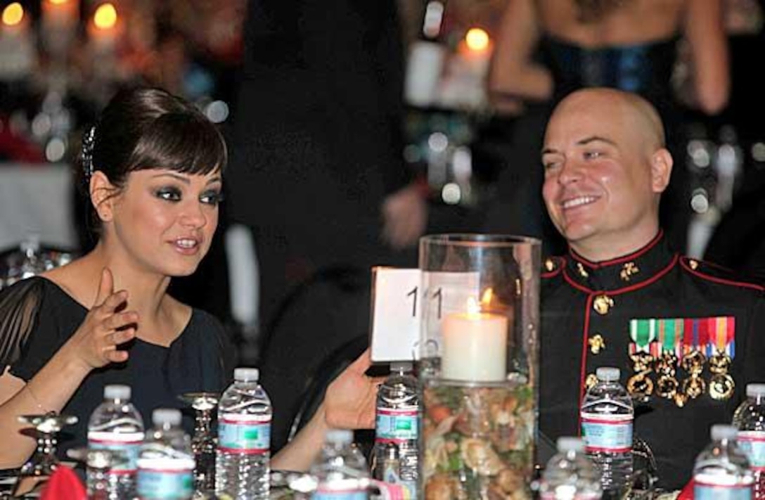 Reserve Marine Sgt. Scott Moore admires Mila Kunis as she tells a story at the Marine Corps Ball on Nov. 18, 2011 in Greenville, N.C. He asked the “Friends with Benefits” star to be his ball date via YouTube while he was deployed in Afghanistan. His video amassed more than four million views and opened the “flood gates” for dozens of other celebrity ball invites on the video-based social network.