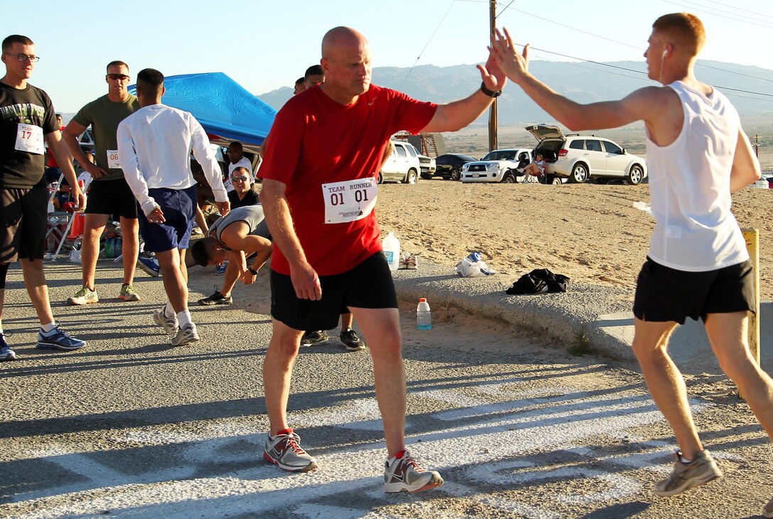 MCAGCC SgtMaj. Matthew Brookshire takes the next leg of the relay from Cpl. James Spivey, G-6, Headquarters Battalion, during the 237th USMC Birthday Endurance Relay Run, Oct. 20 at the East Gym. Brookshire ran for The Base Sergeant Major’s Team, which came in 4th place. Each relay team was comprised of 10 team members who collectively ran 237 miles over the course of three days.