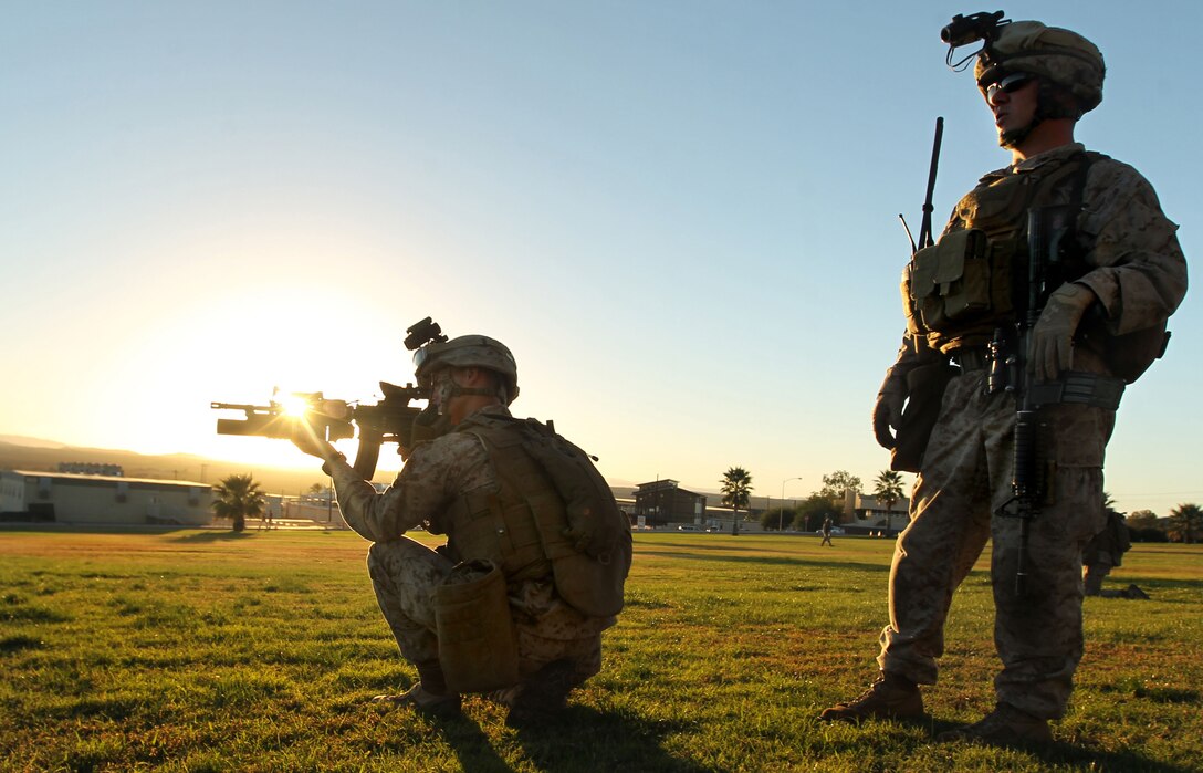 Lance Cpl. Andrew Jeffers, rifleman, Company L., 3rd Battalion 6th Marine Regiment, spots an enemy during a mission rehearsal exercise for a non-combatant evacuation operation Oct. 19 at Lance Cpl. Torrey L. Gray Field. 