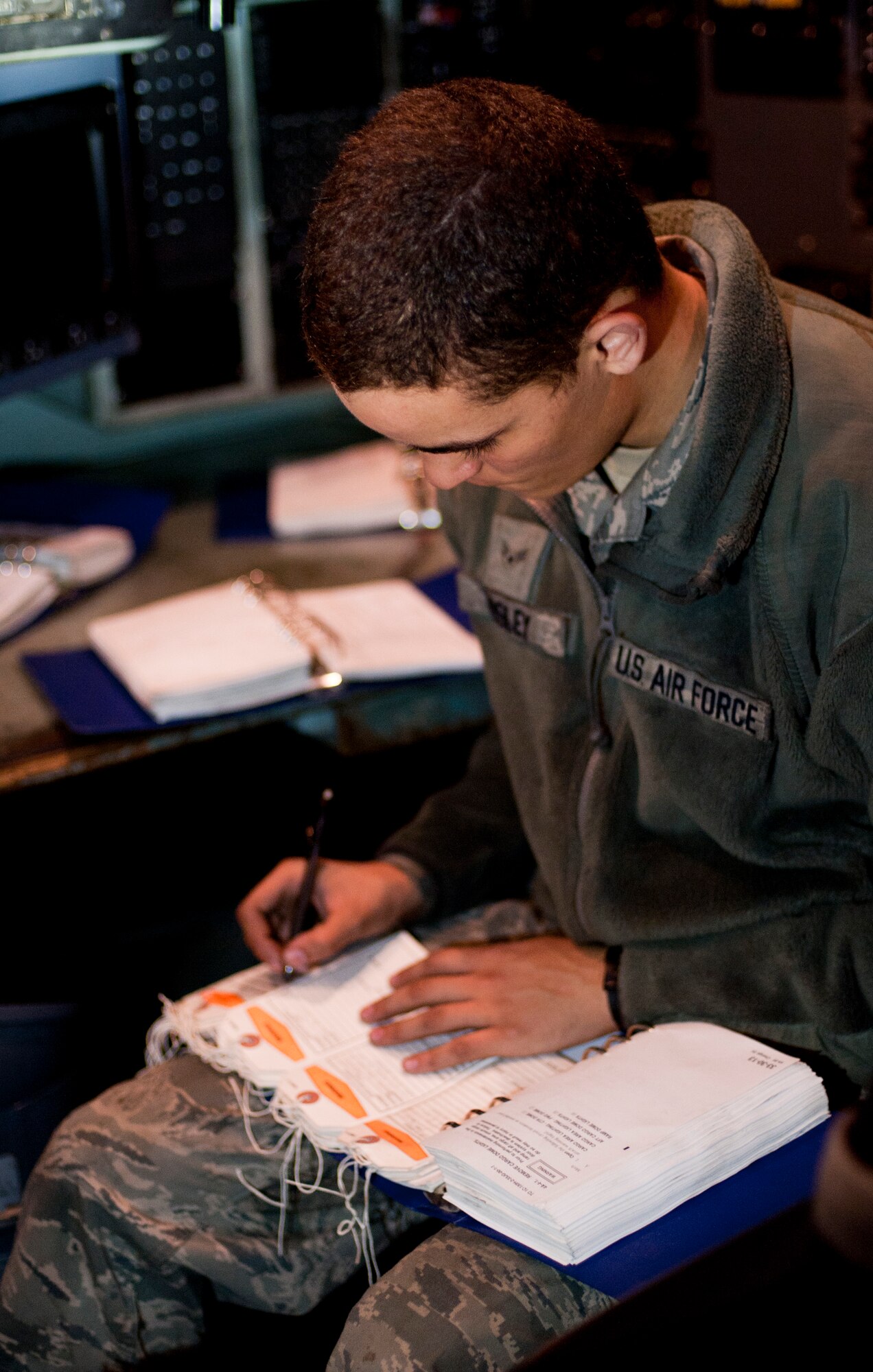 YOKOTA AIR BASE, Japan -- Airman 1st Class Trenton Mosley, 374th Aircraft Maintenance Squadron crewchief, creates warning tags for equipment on a C-130 Hercules at Yokota Air Base, Japan, Oct. 29, 2012. Warning tags notify a person not to use certain equipment while it's being tested. (U.S. Air Force photo by Airman 1st Class Krystal M. Garrett) 