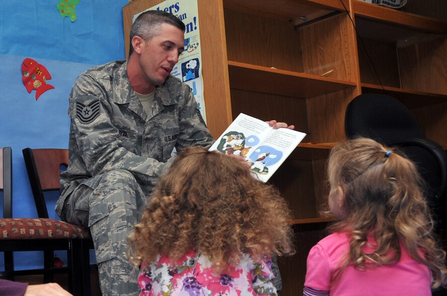Tech. Sgt. Adam Lloyd, 51st Aerospace Medicine Squadron bioenvironmental flight chief, reads to children during preschool story time at Osan Air Base, Republic of Korea, Nov. 1, 2012. Lloyd is a regular volunteer with the program. (U.S. Air Force photo/Staff Sgt. Craig Cisek)
