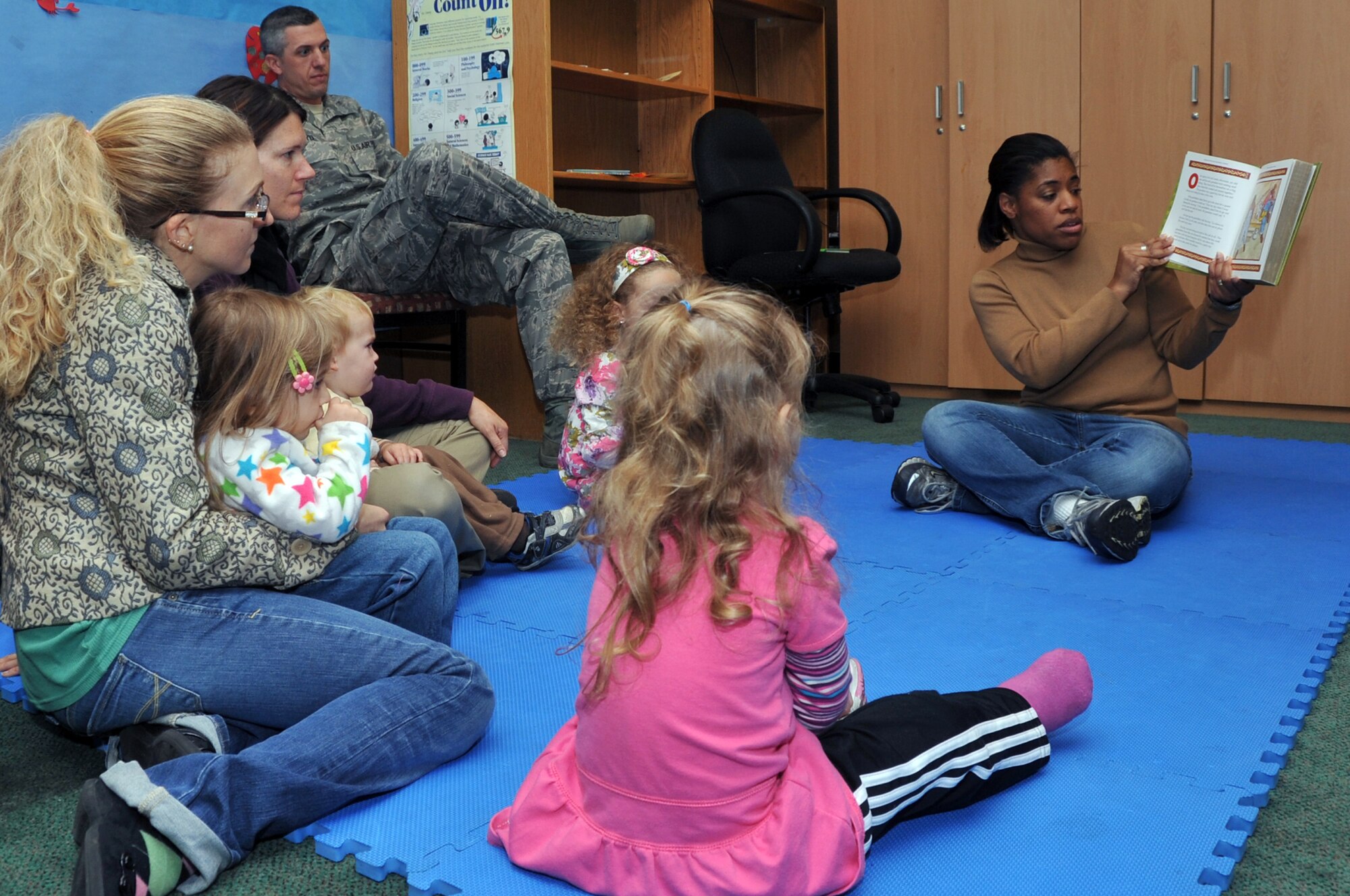 Tiffany Hagarty reads to children as part of preschool story time hosted by the base library, Nov. 1, 2012. Haggarty took lead position in the program and feels it boosts social interaction among children. (U.S. Air Force photo/Staff Sgt. Craig Cisek)