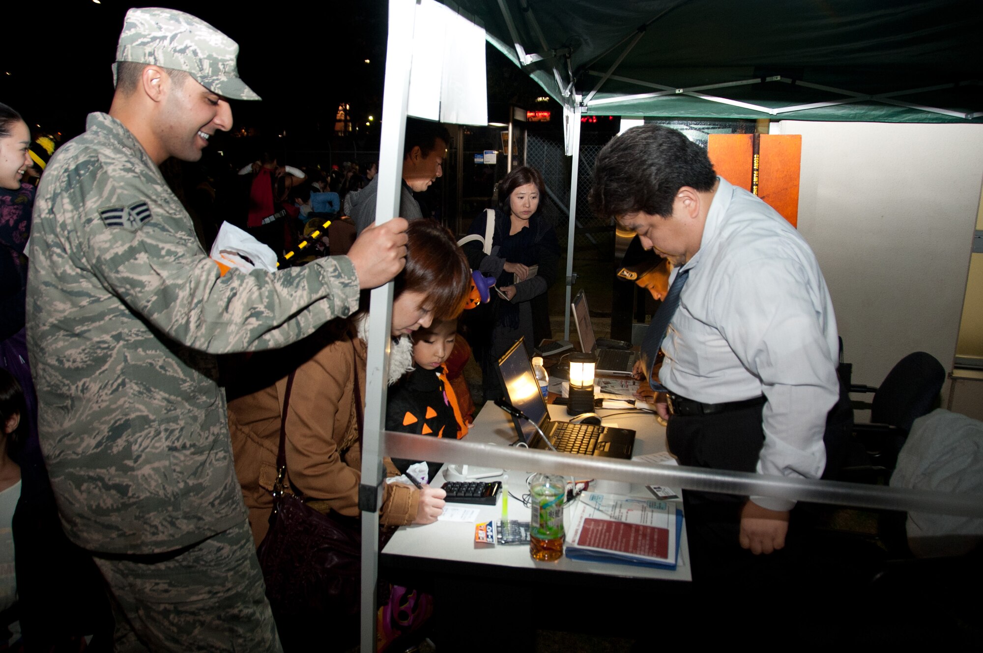 YOKOTA AIR BASE, Japan -- Japanese guests register for trick-or-treating activities at the visitor's center Oct. 31, 2012, at Yokota Air Base, Japan. Each year, base residents have the opportunity to share the American tradition with their Japanese friends. (U.S. Air Force photo by Airman 1st Class Desiree Economides)