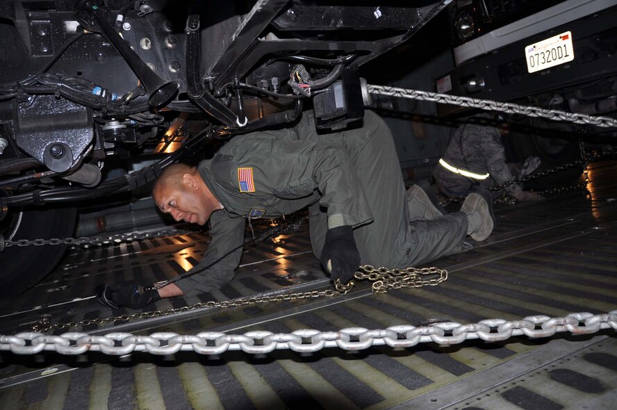 Reservists and technicians from March Air Reserve Base, Calif., answered the President's call to 'lean forward' with Hurricane Sandy relief efforts here Nov. 1, 2012, by loading Southern California Edison equipment onto a Travis Air Force Base C-5 Galaxy and a Joint Base Lewis-McChord C-17 Globemaster III. Here an Edison truck is secured in the cargo bay of a C-5. (U.S. Air Force photo/Linda Welz)