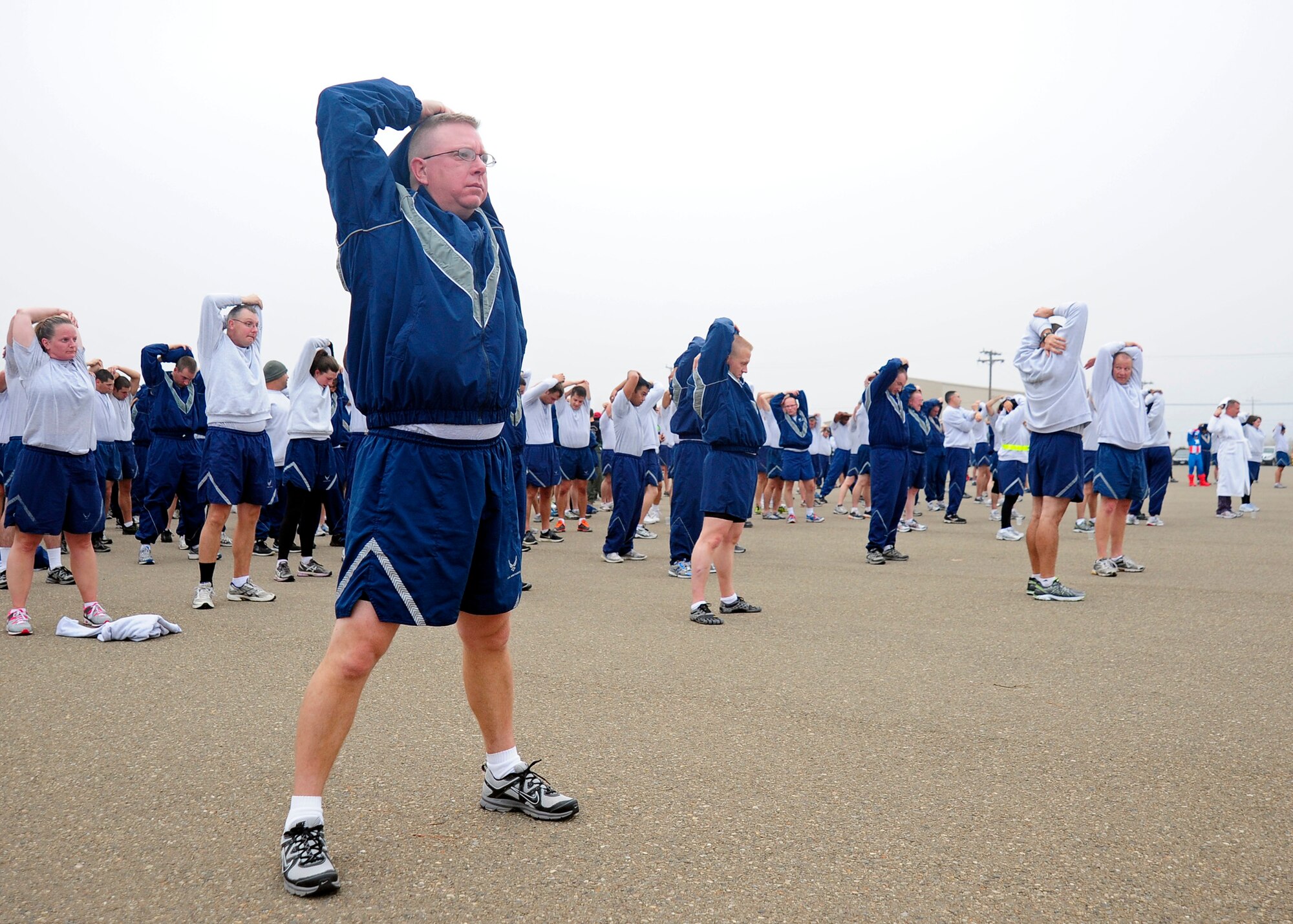 VANDENBERG AIR FORCE BASE, Calif. -- Team Vandenberg members stretch during a group cool-down after the monthly wing run here Wednesday, Oct. 31, 2012. Team V members were invited to participate in the Wing Run in costume in celebration of Halloween.(U.S. Air Force photo/Michael Peterson)