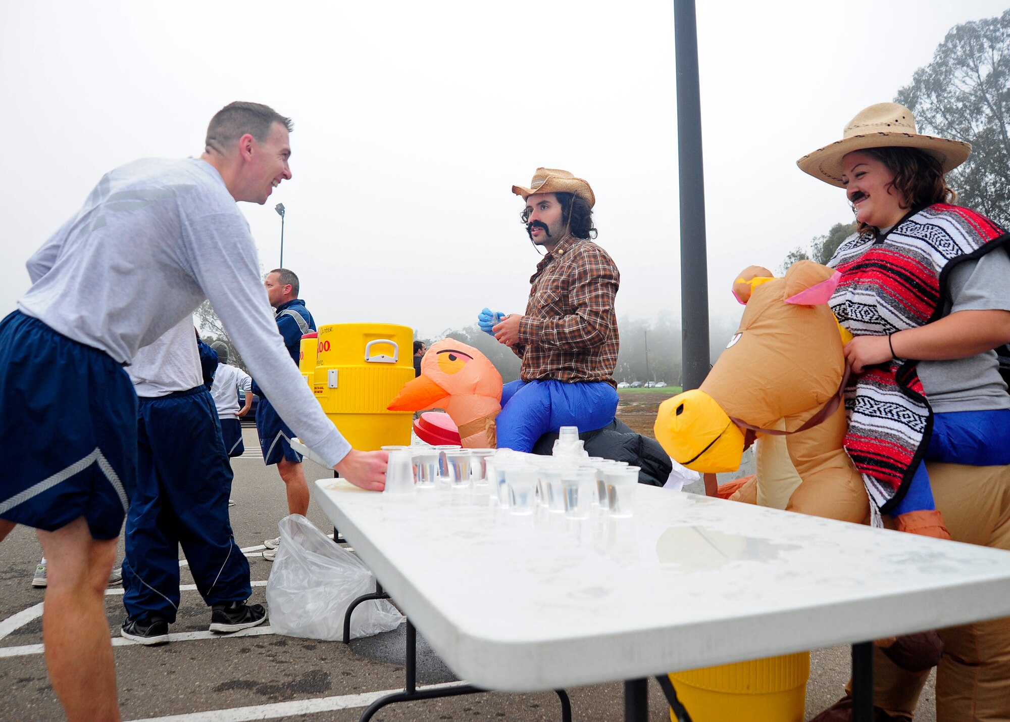 VANDENBERG AIR FORCE BASE, Calif. --Sal Rodriquez and Sandra Marquez, Fitness Center staff members, patrol the water table as Team V members finish the wing run here Wednesday, Oct. 31, 2012. Team V members were invited to participate in costume in celebration of Halloween.(U.S. Air Force photo/Michael Peterson)