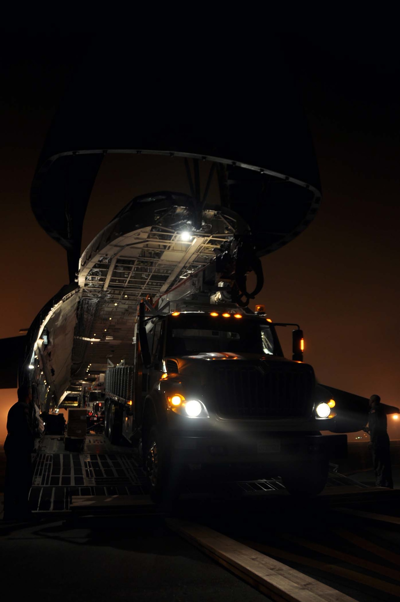 Reservists and technicians from March Air Reserve Base, Calif., answered the President's call to 'lean forward' with Hurricane Sandy relief efforts here Nov. 1, 2012, by loading Southern California Edison equipment onto a Travis Air Force Base C-5 Galaxy and a Joint Base Lewis-McChord C-17 Globemaster III. Here an Edison truck is loaded into the cargo bay of a C-5. (U.S. Air Force photo/Linda Welz) 