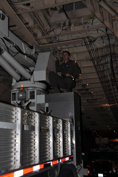 Reservists and technicians from March Air Reserve Base, Calif., answered the President's call to 'lean forward' with Hurricane Sandy relief efforts here Nov. 1, 2012, by loading Southern California Edison equipment onto a Travis Air Force Base C-5 Galaxy and a Joint Base Lewis-McChord C-17 Globemaster III. Here Team March member checks the height clearance of an Edison truck as it is loaded into the cargo bay of a C-5. (U.S. Air Force photo/Linda Welz)