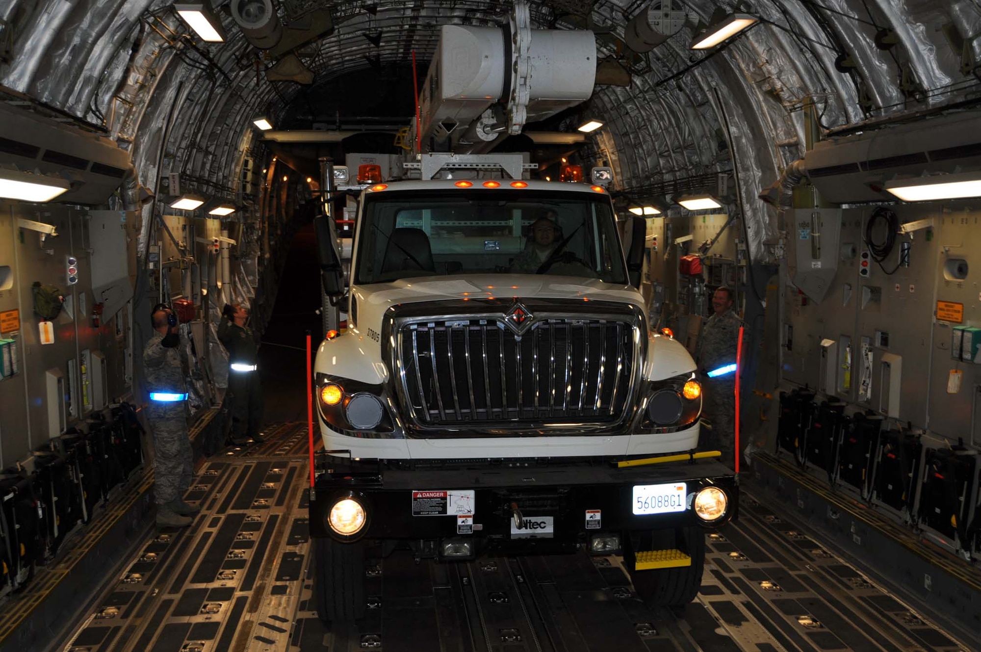 Reservists and technicians from March Air Reserve Base, Calif., answered the President's call to 'lean forward' with Hurricane Sandy relief efforts here Nov. 1, 2012, by loading Southern California Edison equipment onto a Travis Air Force Base C-5 Galaxy and a Joint Base Lewis-McChord C-17 Globemaster III. Here an Edison truck is loaded into the cargo bay of a C-17. (U.S. Air Force photo/Linda Welz) 