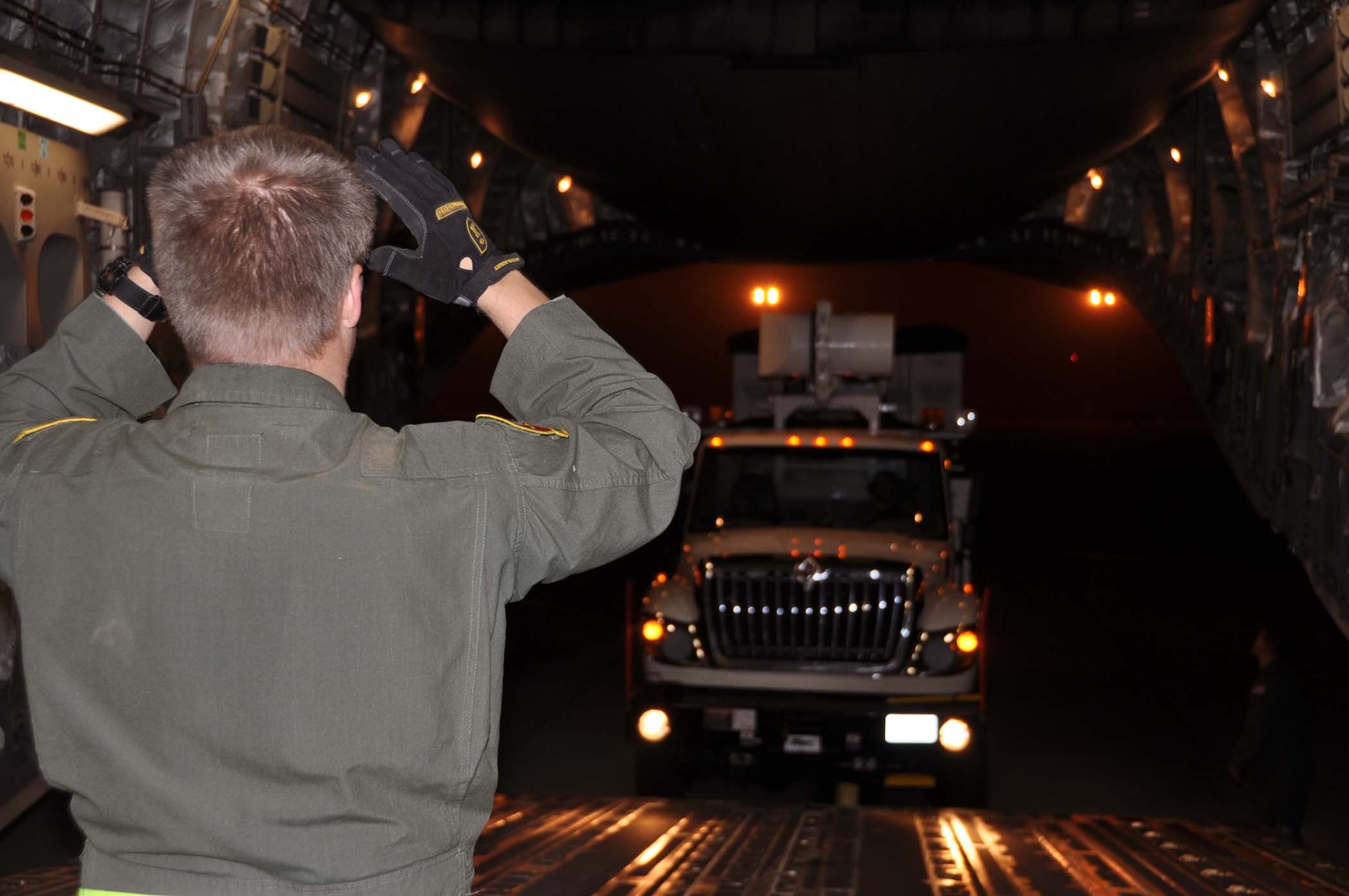 Reservists and technicians from March Air Reserve Base, Calif., answered the President's call to 'lean forward' with Hurricane Sandy relief efforts here Nov. 1, 2012, by loading Southern California Edison equipment onto a Travis Air Force Base C-5 Galaxy and a Joint Base Lewis-McChord C-17 Globemaster III. Here an Edison truck is loaded into the cargo bay of a C-17. (U.S. Air Force photo/Linda Welz) 