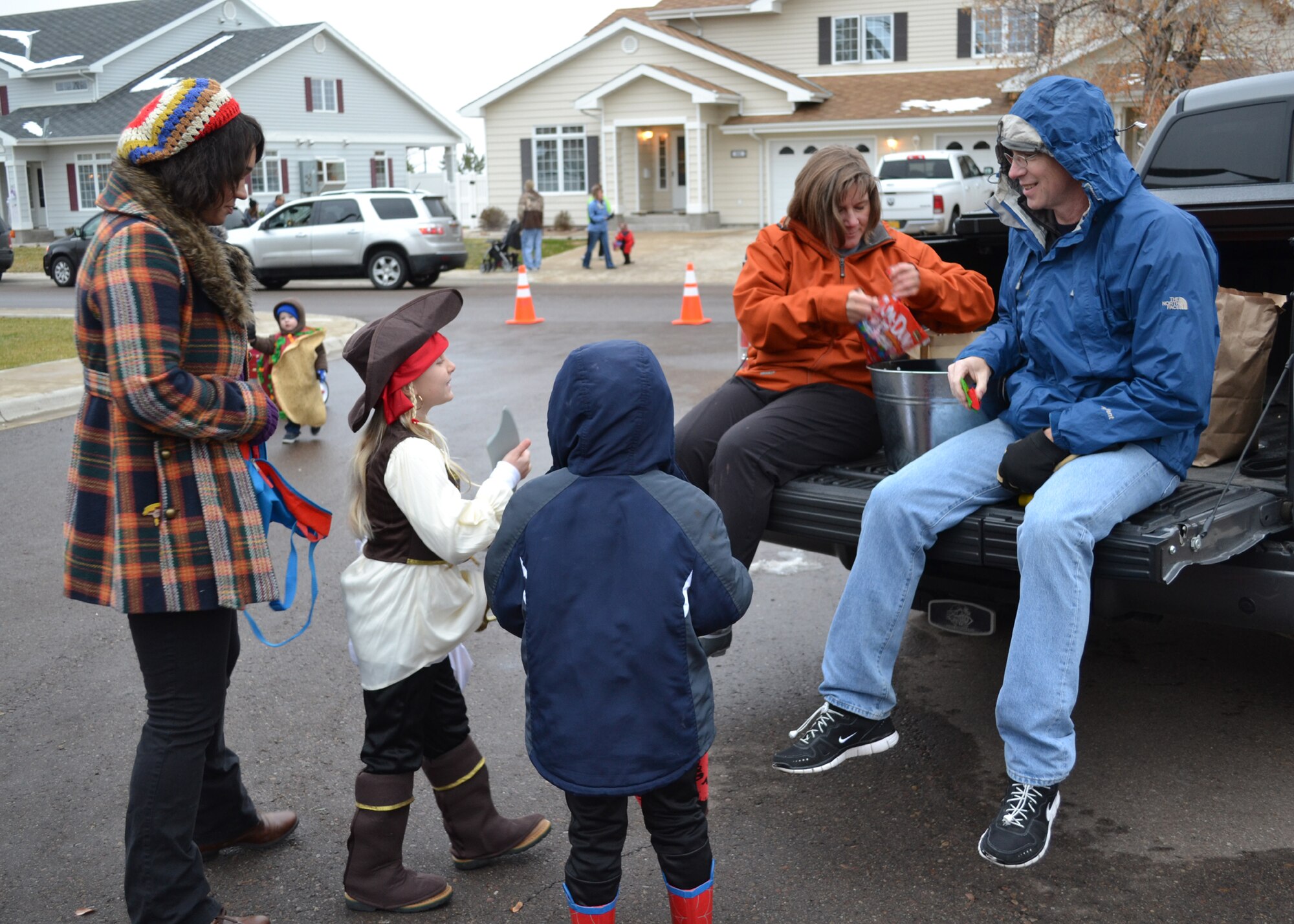 Col. Angela Stout, 341st Missile Support Group commander, and her husband Mark hand out candy to the children trick-or-treating.  Along with candy, the attending families got free popcorn as well as hotdogs and lemonade.  (U.S. Air Force photo/Airman 1st Class Cortney Paxton)
