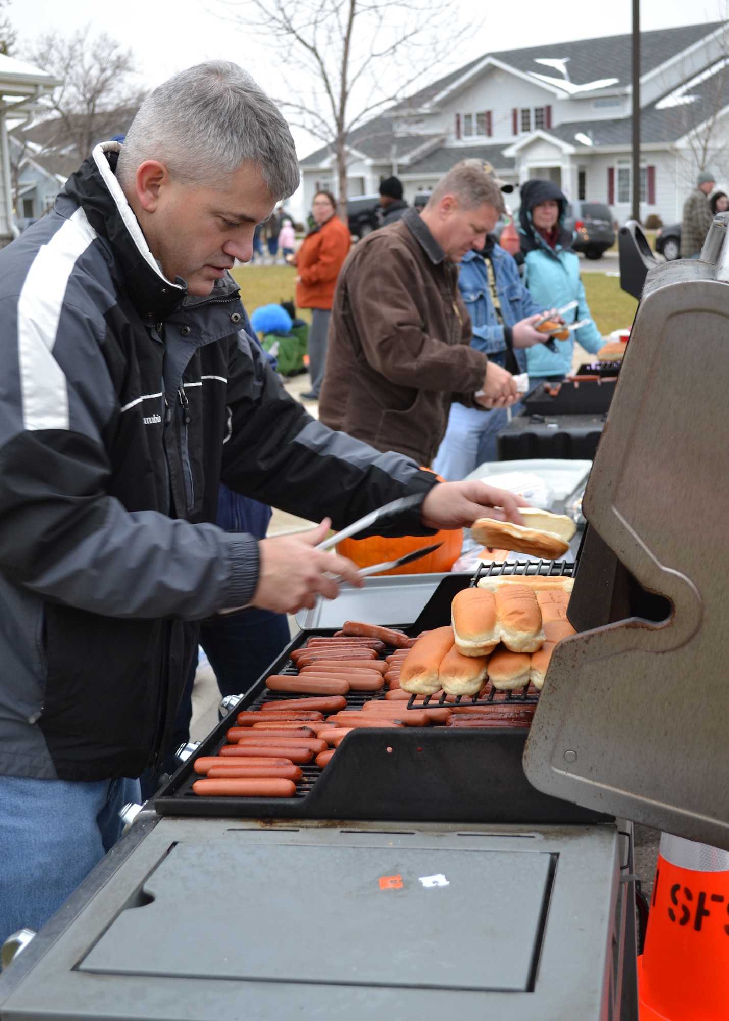 Col. Mark Schuler, 341st Operations Group commander, alongside other members of wing leadership, cook and serve hotdogs for the families attending the 341st Missile Wing commander and command chief’s Halloween party on Oct. 26.  Children of all ages showed up to the event with their parents to grab a hotdog before heading around the housing areas to trick-or-treat.  (U.S. Air Force Photo/Airman 1st Class Cortney Paxton)