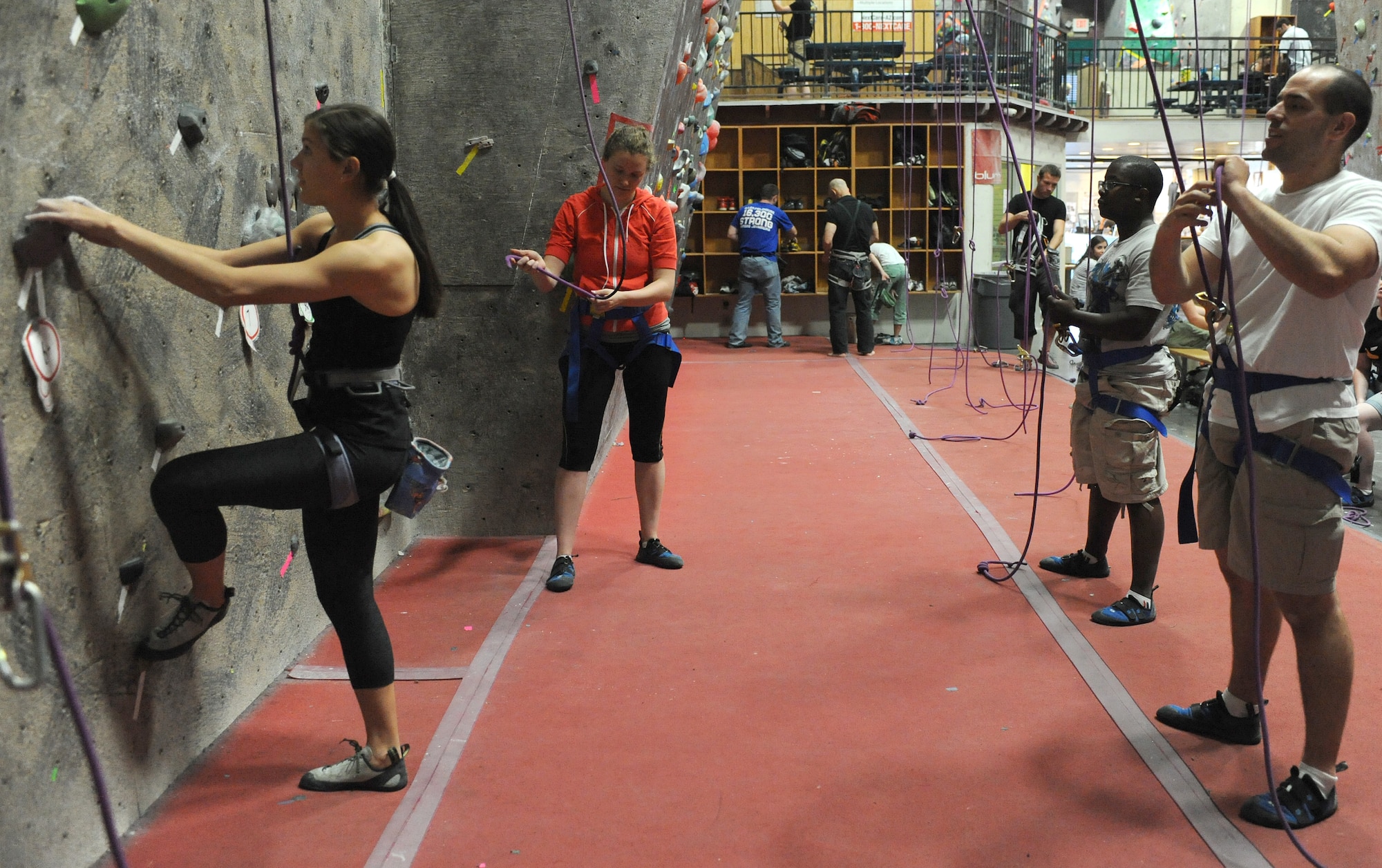 Airmen from Davis-Monthan Air Force Base prepare to ascend a rock climbing wall during an event held by the Single Airmen Initiative program in Tucson, Ariz. March 31. The program is targeted to single active-duty or reserve officers and enlisted members without dependants. However, the program is open to all patrons authorized to use the 355th Force Support Squadron programs. (U.S. Air Force photo by Airman 1st Class Christine Griffiths)