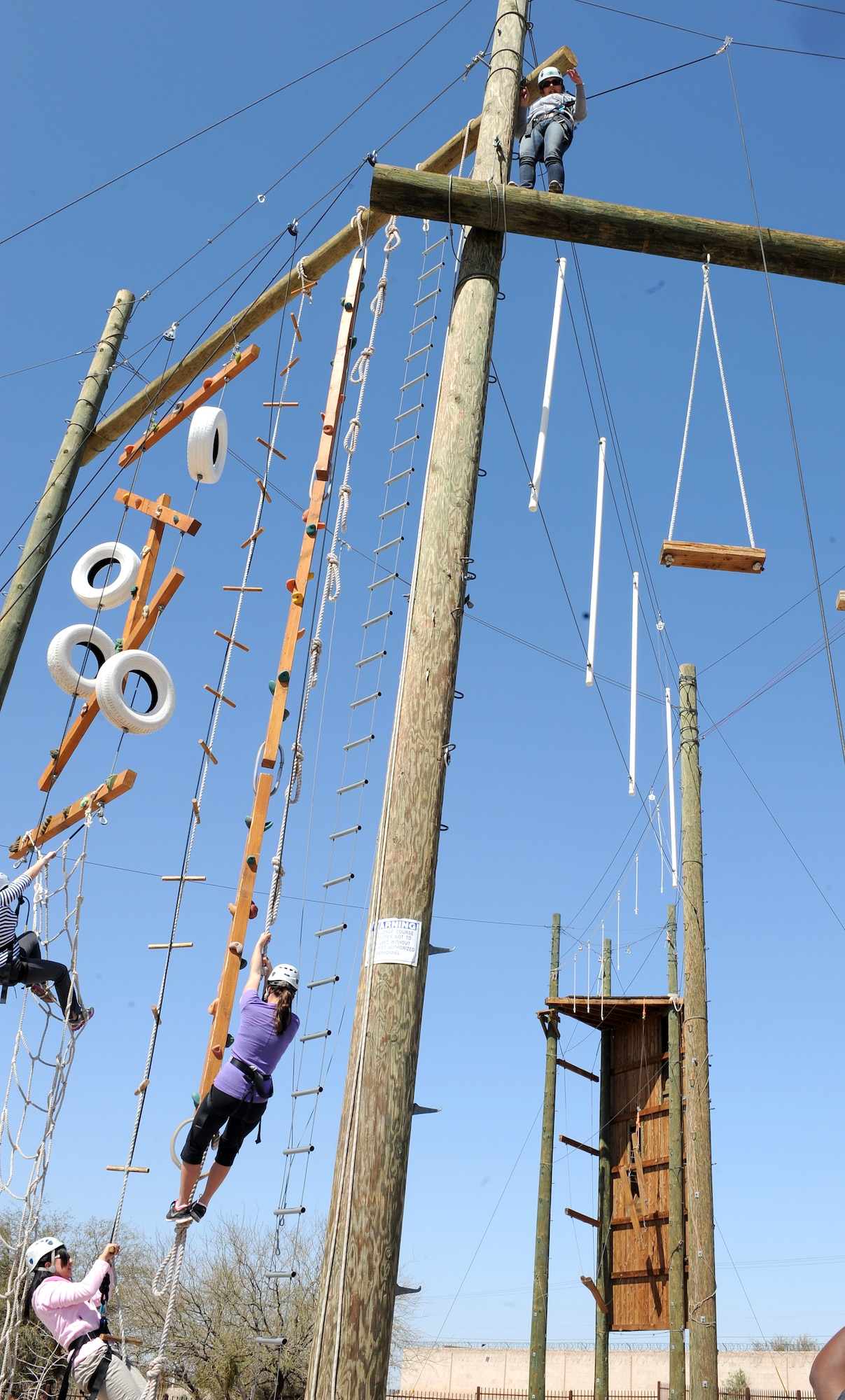 Members of the Desert Lightning Team scale obstacles at the 4H High Ropes course held by the Single Airmen Initiative program in Tucson, Ariz. March 8. The SAI is an Air Force-wide program endorsed by the Chief Master Sergeant of the Air Force. (Courtesy photo)