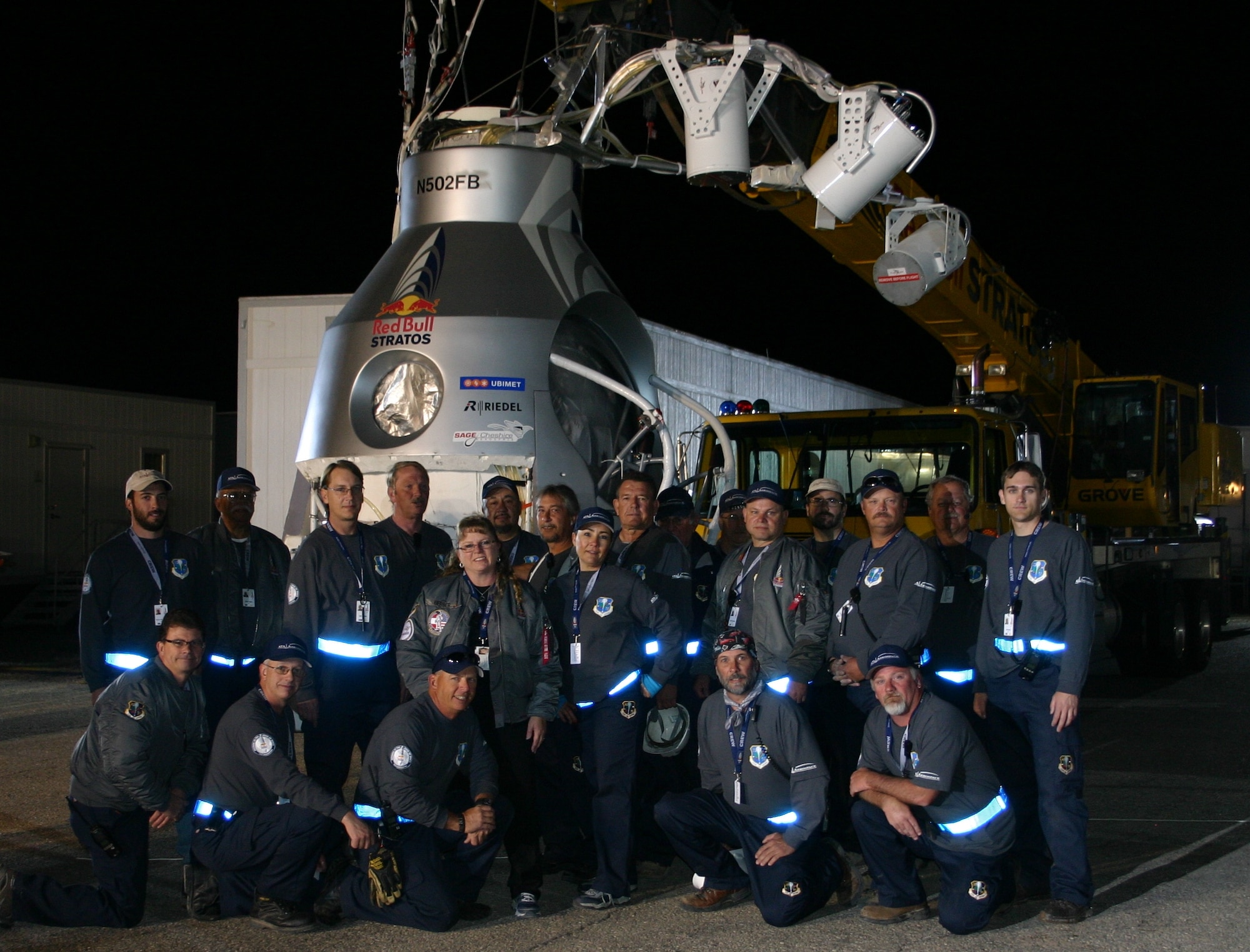 KIRTLAND AFB, N.M. -- The launch crew for Felix Baumgartner’s historic leap from near-space stand in front of the 2,900-pound capsule, which would take the Austrian daredevil to an altitude of 128,000 feet, a few hours before liftoff Oct. 14. Harold “Vernon” Baker, who serves with the Air Force Research Laboratory’s Space Vehicles Directorate, (back row, fourth from left) and ATA Aerospace employee Tracy Gerber (front row, fourth from left) played significant roles in the record-breaking event. (Courtesy photo)