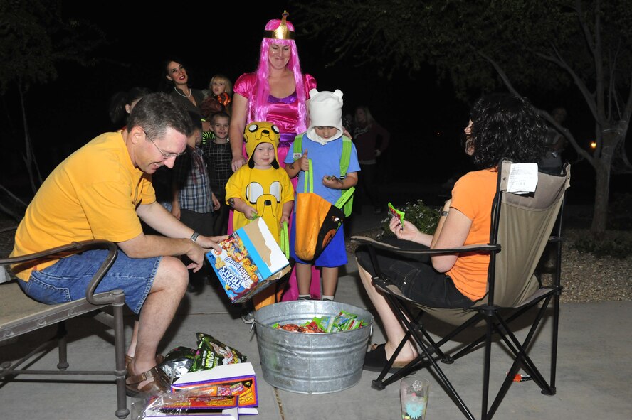 Brig. Gen. Mike Rothstein, 56th Fighter Wing commander, and his wife, Jennifer, hand out candy to trick or treaters at Luke Air Force Base, Ariz., Oct. 31, 2012. (U.S. Air Force photo by Staff Sgt. Jason Colbert)