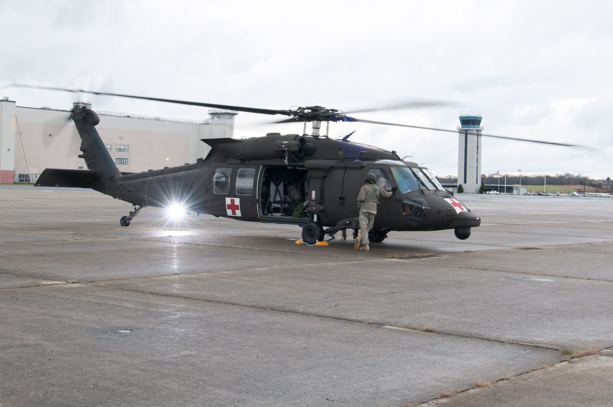 HANSCOM AIR FORCE BASE, Mass. – Members of the 10th Mountain Division Combat Aviation Brigade offload a UH-60 Blackhawk helicopter after arriving here Oct. 31. The brigade is at Hanscom as part of the USNORTHCOM Defense Support of Civil Authorities mission that directs the command to plan and anticipate action that it may need to take to support civil authorities. USNORTHCOM plays an important role in disaster response; however, all efforts for Hurricane Sandy are in support of FEMA, working closely with state and local officials. (U.S. Air Force photo by Rick Berry)