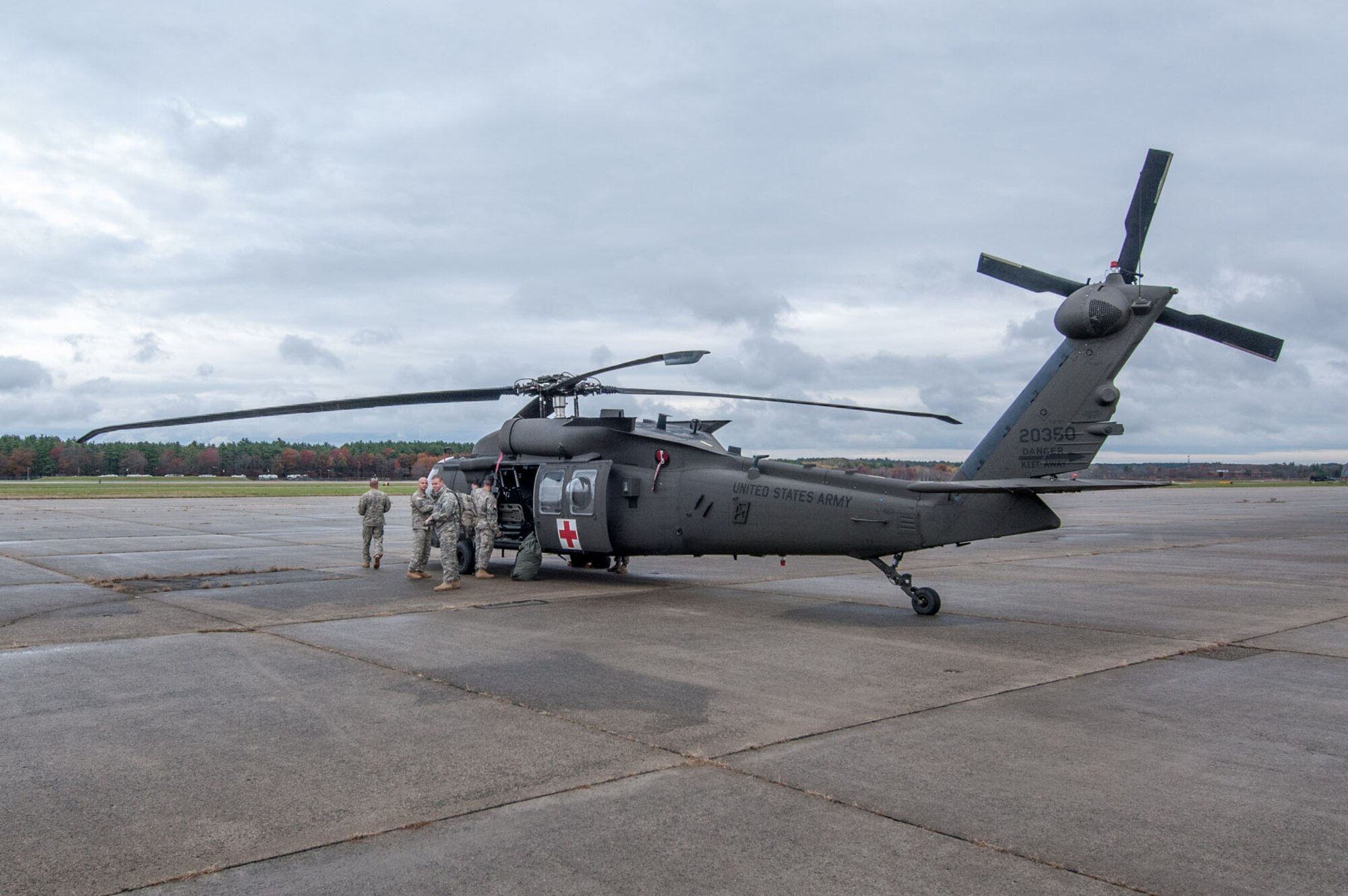 HANSCOM AIR FORCE BASE, Mass. – Members of the 10th Mountain Division Combat Aviation Brigade offload a UH-60 Blackhawk helicopter after arriving here Oct. 31. The brigade is at Hanscom as part of the USNORTHCOM Defense Support of Civil Authorities mission that directs the command to plan and anticipate action that it may need to take to support civil authorities. USNORTHCOM plays an important role in disaster response; however, all efforts for Hurricane Sandy are in support of FEMA, working closely with state and local officials. (U.S. Air Force photo by Rick Berry)